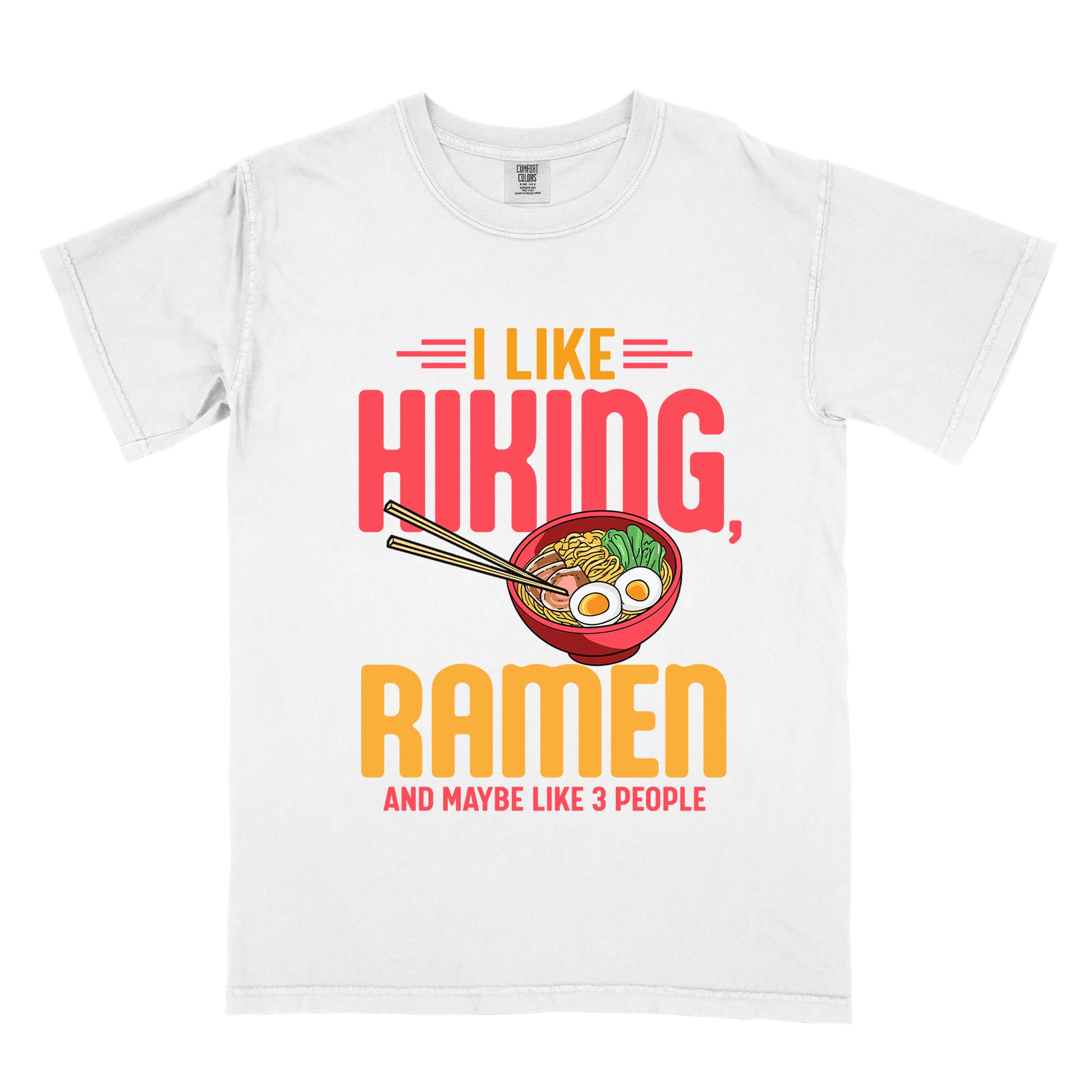 White t-shirt with text "I LIKE HIKING, RAMEN AND MAYBE LIKE 3 PEOPLE". "I LIKE" appears in orange at the top with red decorative lines, "HIKING," in large red letters, "RAMEN" in yellow/orange, and "AND MAYBE LIKE 3 PEOPLE" in red at the bottom. Between "HIKING" and "RAMEN" is a colorful illustration of a red ramen bowl with noodles, egg, and vegetables, with chopsticks.