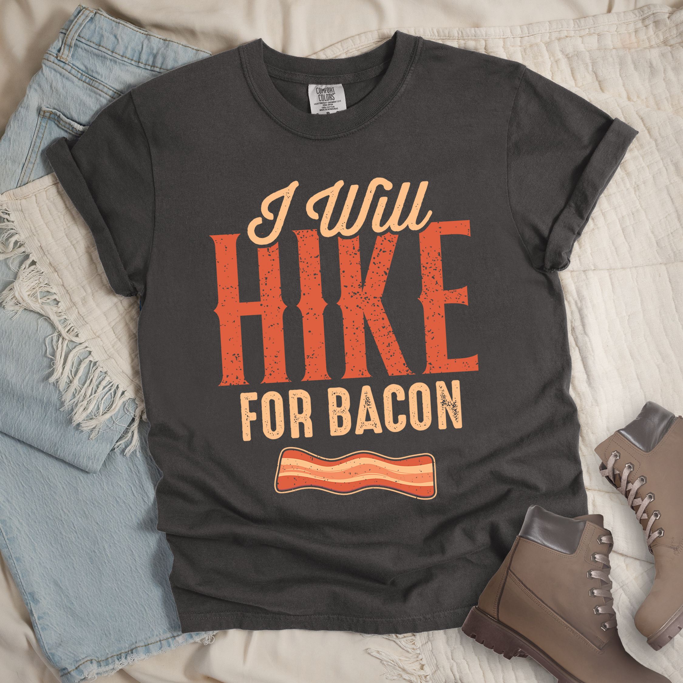 Dark grey shirt with the text “I Will Hike for Bacon” and an illustration of a bacon strip.