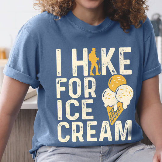 Blue Jean (Denim Blue) graphic t-shirt with 'I Hike for Ice Cream' text in cream lettering featuring orange hiker silhouette and vanilla and mango ice cream cone illustration with waffle cone.