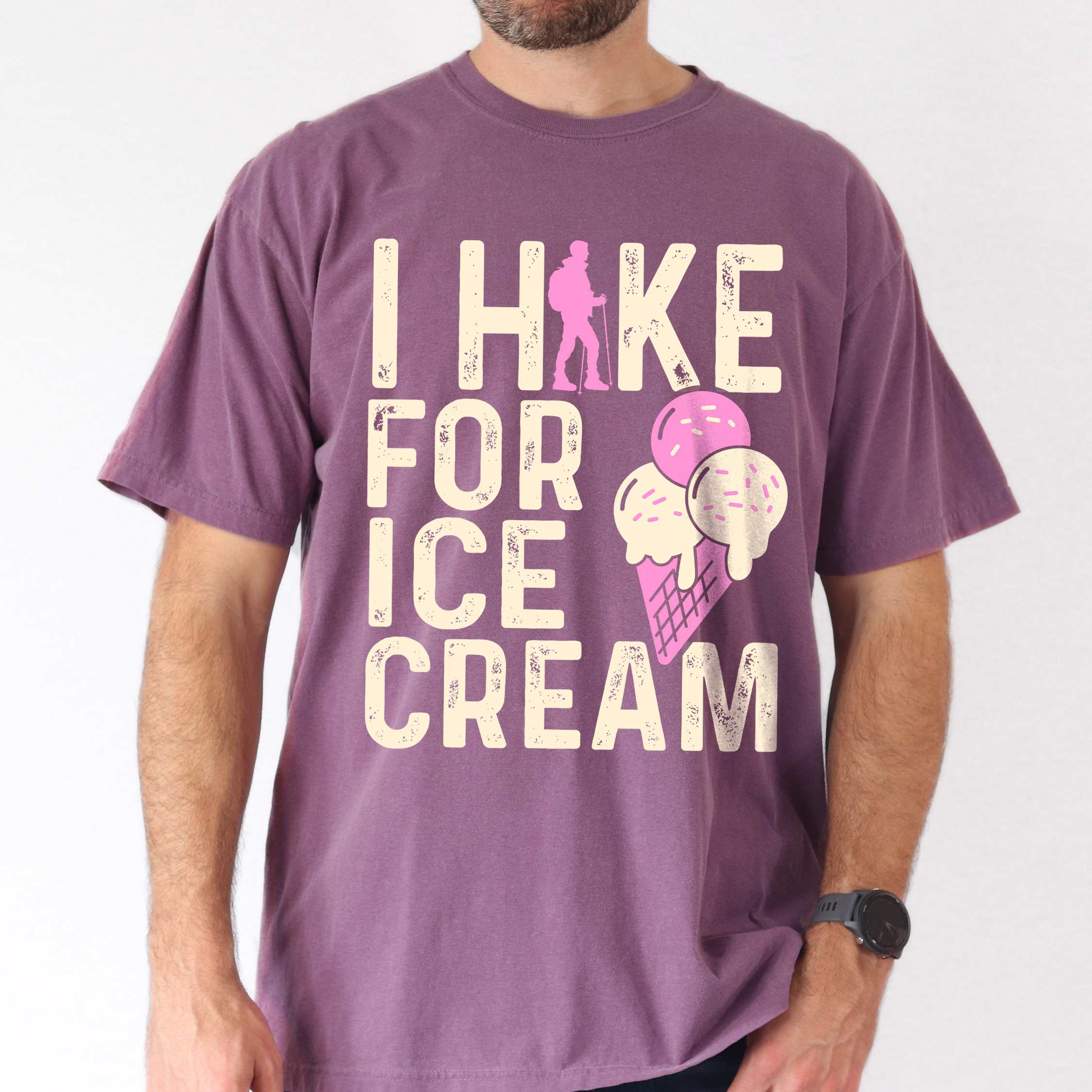 Man wearing berry I Hike for Ice Cream statement tee with vintage distressed typography, hiker silhouette, and double-scoop ice cream cone illustration on Comfort Colors shirt for dessert-loving outdoor enthusiasts and hikers