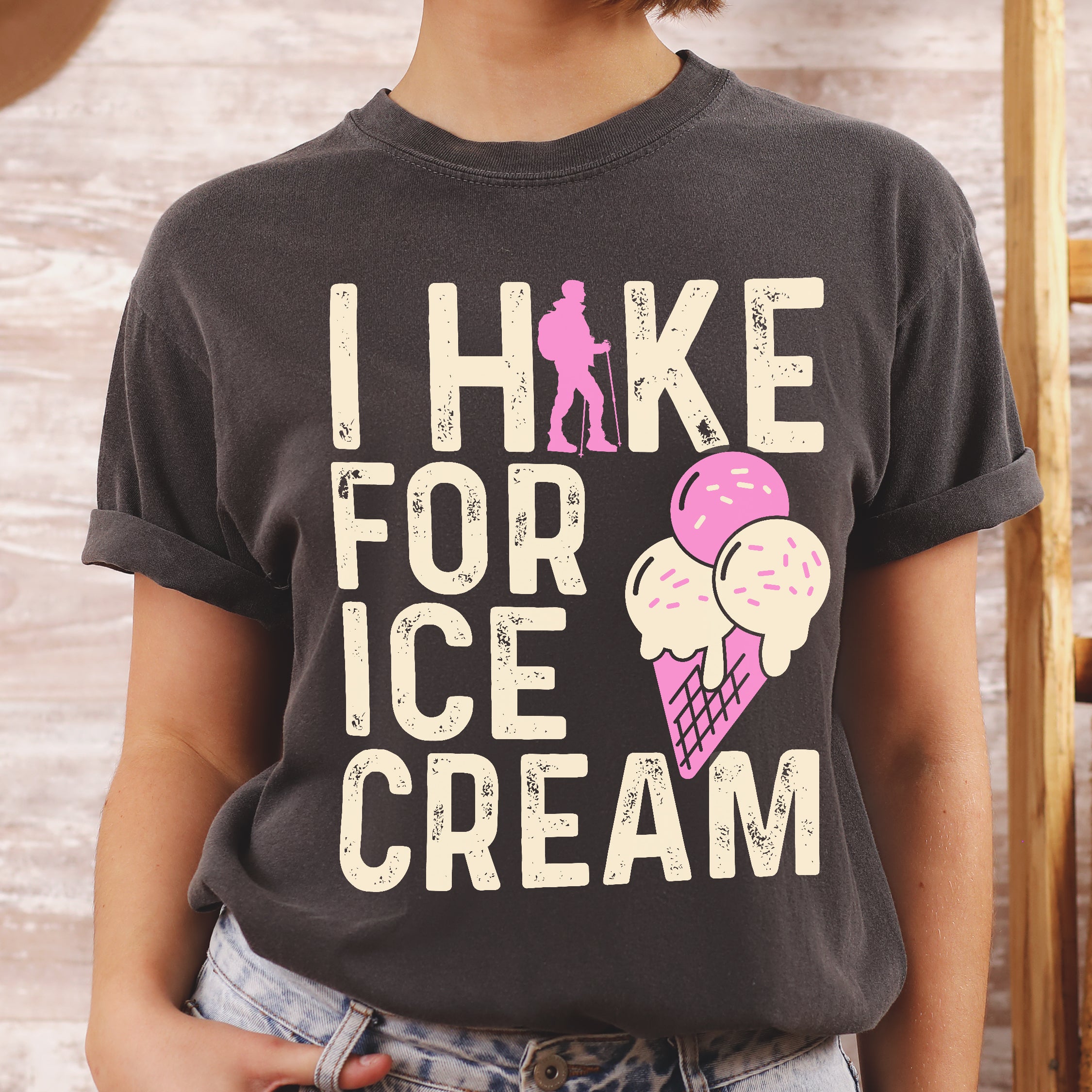 Pepper (Dark Gray) graphic t-shirt with 'I Hike for Ice Cream' text in cream lettering featuring pink hiker silhouette and colorful ice cream cone illustration with pink and cream scoops in purple waffle cone.