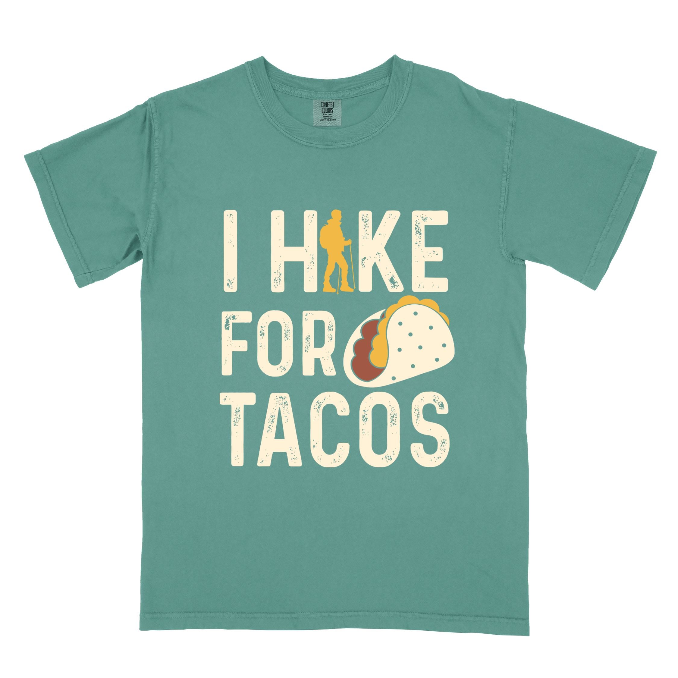 Light green colored vintage tee with 'I Hike for Tacos' text in cream lettering, illustrated taco, and backpacker for taco lovers