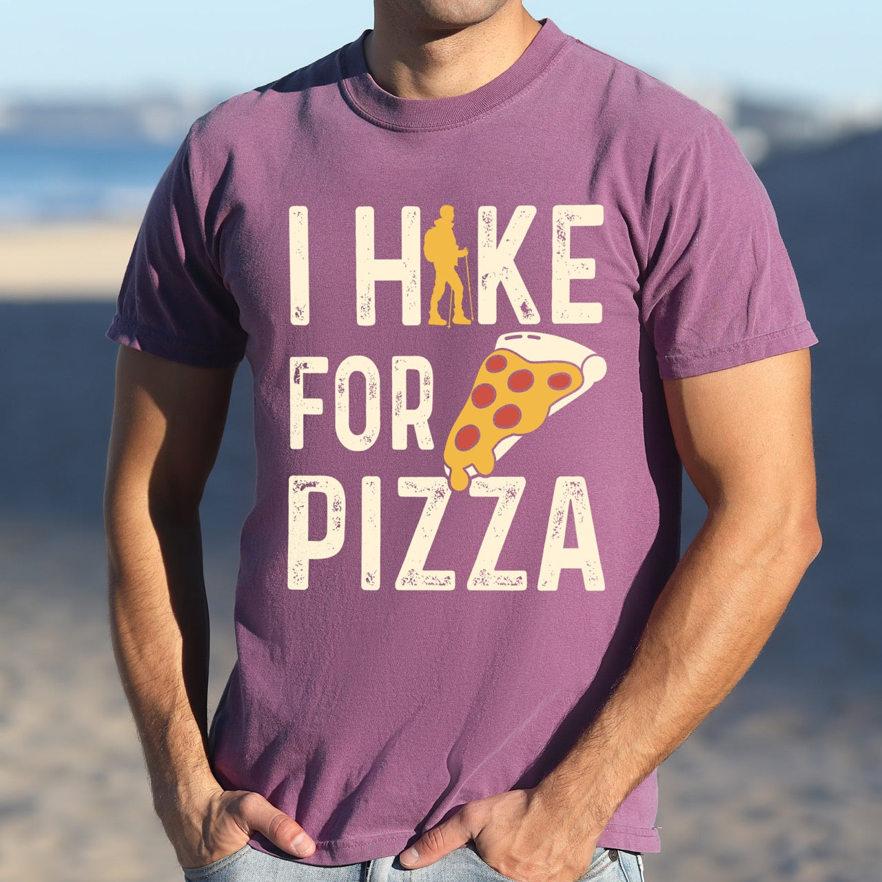 berry  I Hike for Pizza graphic tee with distressed cream typography, pepperoni pizza slice illustration, and gold hiker silhouette on Comfort Colors shirt for Italian food enthusiasts and mountain trail lovers