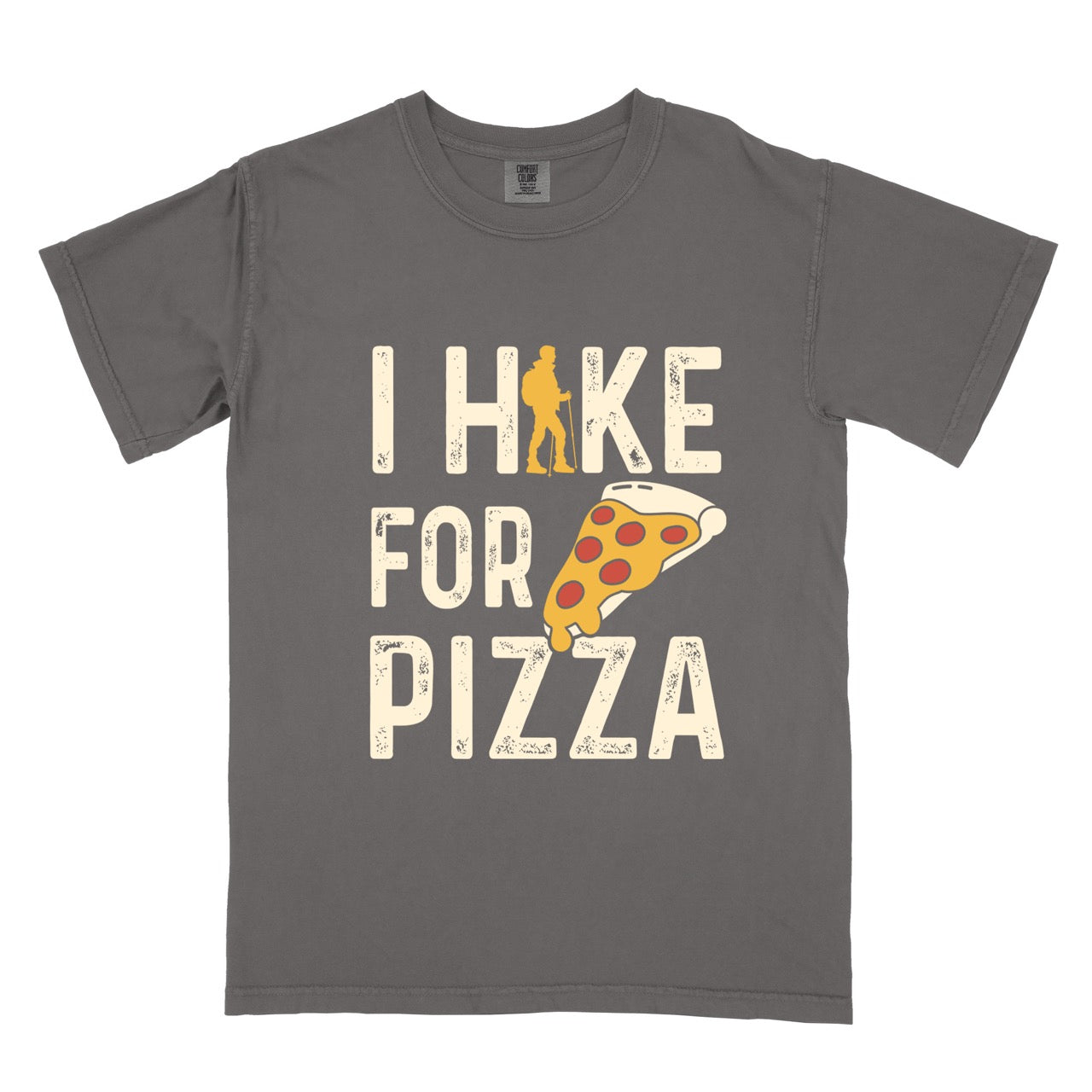 pepper  I Hike for Pizza graphic tee with distressed cream typography, pepperoni pizza slice illustration, and gold hiker silhouette on Comfort Colors shirt for Italian food enthusiasts and mountain trail lovers