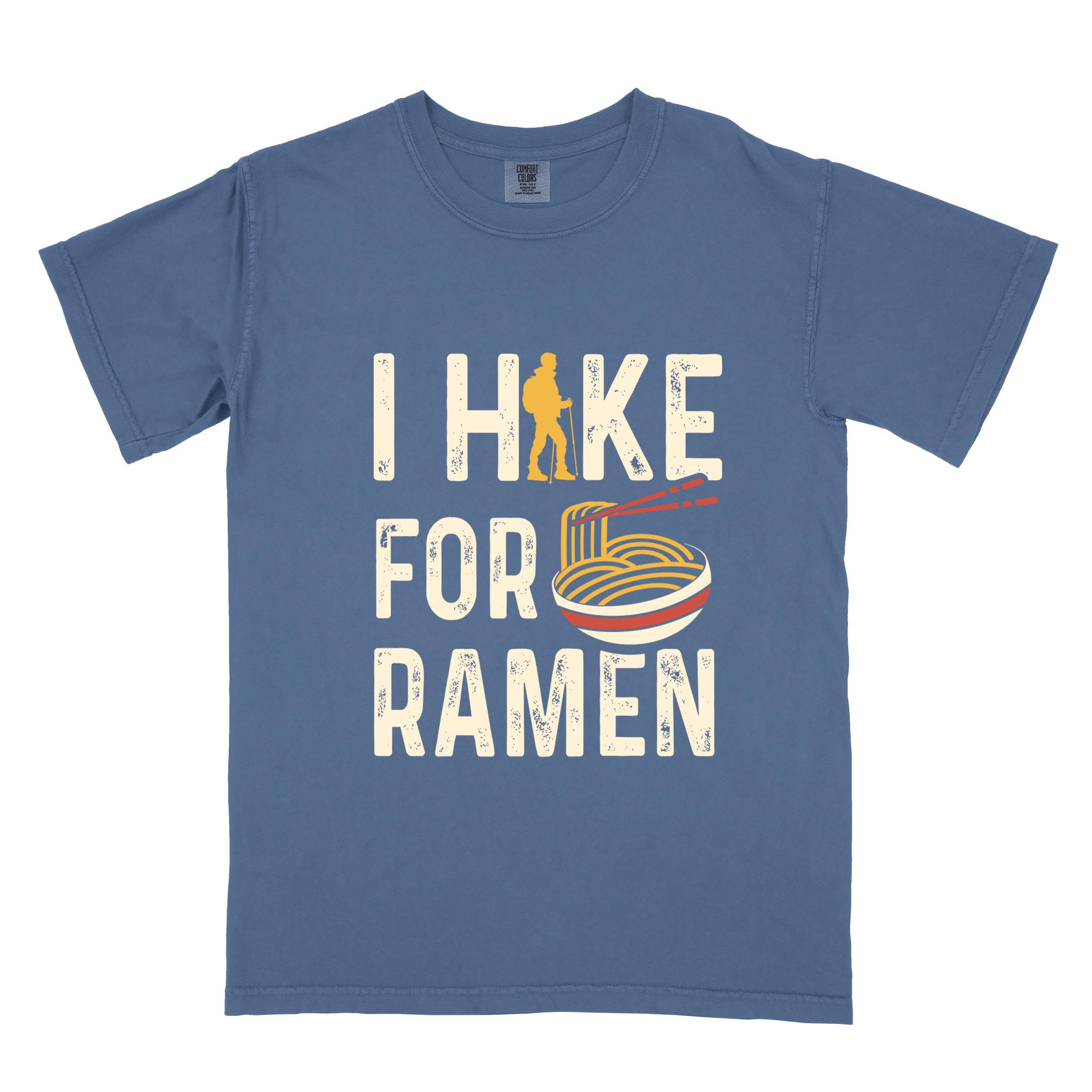 Blue jean colored vintage tee with 'I Hike for Ramen' text in cream lettering, illustrated taco, and backpacker for ramen lovers