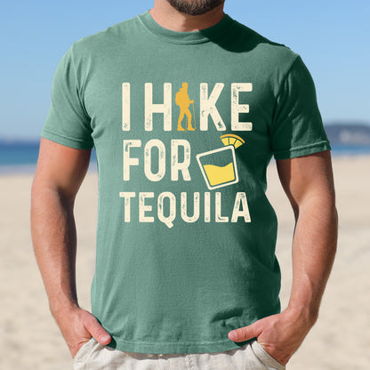 Light Green graphic t-shirt with 'I Hike for Tequila' text in cream lettering featuring orange hiker silhouette and tequila shot glass illustration with lime garnish.