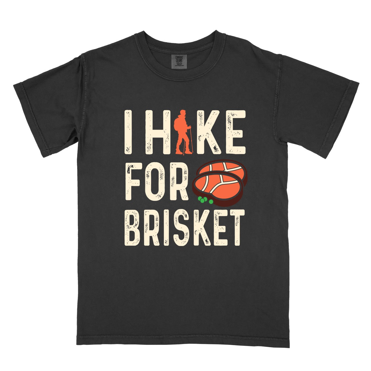 Black BBQ brisket lover statement tee I Hike for Brisket with distressed brown typography character silhouette with trekking pole and illustrated sliced smoked brisket with herb garnish on vintage Comfort Colors shirt for food motivated adventurers for hikers and foodies. 