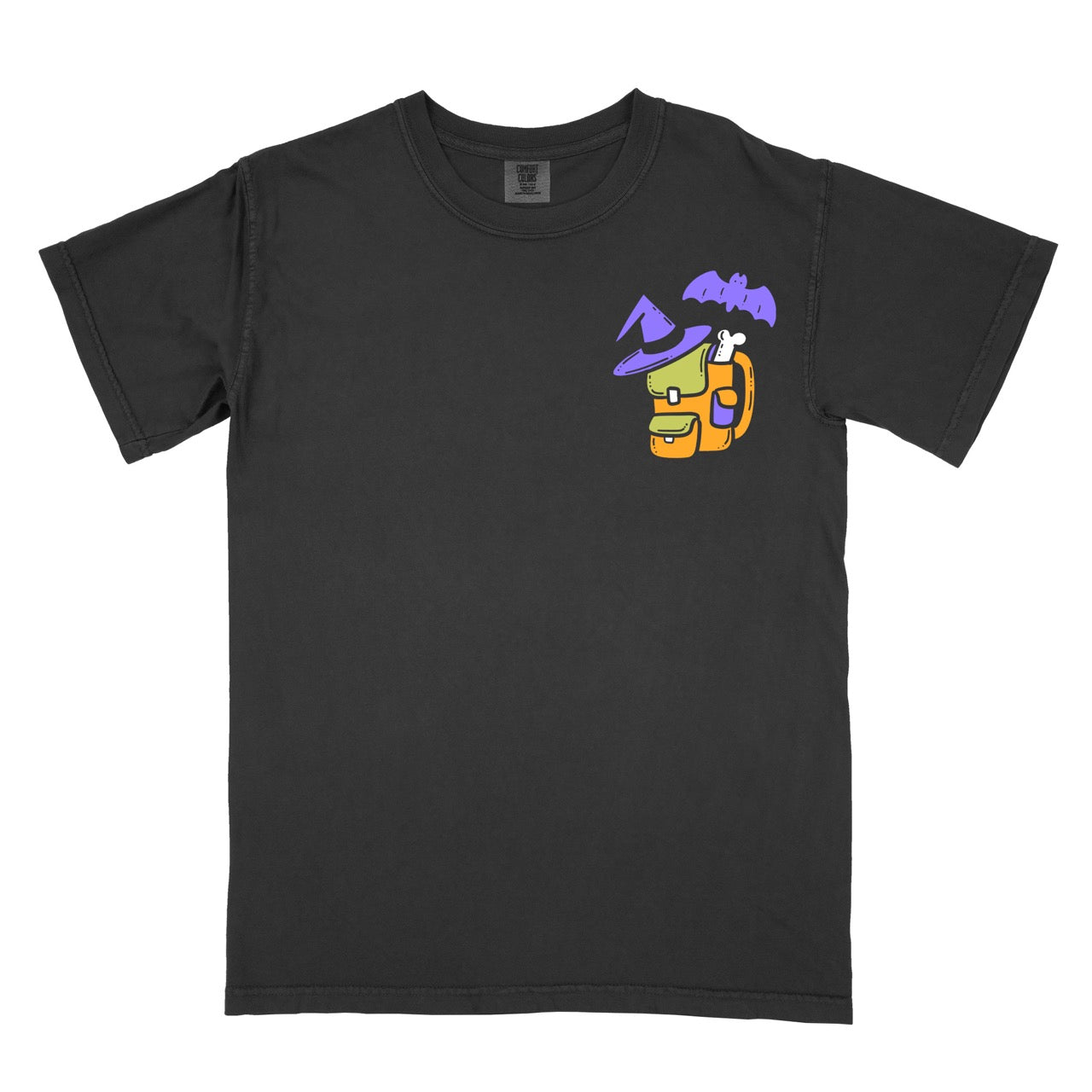 Cute Halloween statement shirt Bewitched Backpacker featuring yellow and orange backpack with purple witch hat dog bone accessory and flying bat chest placement design on Comfort Colors tee for playful spooky season celebrations
