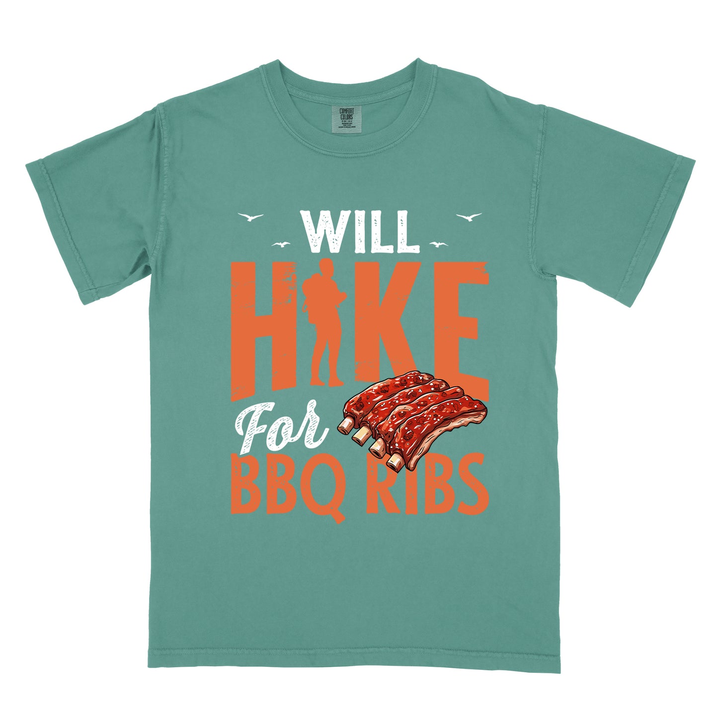 Light Green t-shirt with text "WILL HIKE For BBQ RIBS". "WILL" appears in white distressed letters at the top with small bird silhouettes. "HIKE" is in large orange distressed text with a hiker silhouette replacing the letter "I". "For" appears in white script, and "BBQ RIBS" in matching orange at the bottom. Between "For" and "BBQ RIBS" is an illustration of a rack of barbecue ribs with exposed bones.