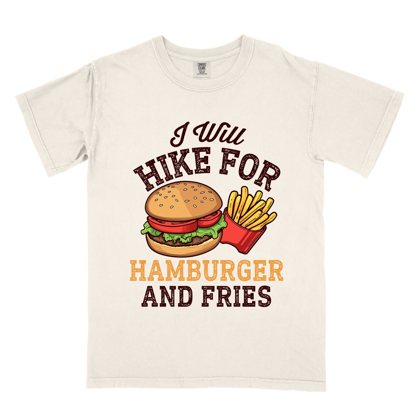 Ivory (Cream White) t-shirt with deep brown distressed text reading "I Will HIKE FOR HAMBURGER AND FRIES". The words "I Will" appear in deep brown script at the top, "HIKE FOR" in deep brown block letters, "HAMBURGER" in gold/orange, and "AND FRIES" in deep brown at the bottom. Center illustration shows a detailed hamburger with bun, patty, lettuce, and tomato next to a red container of yellow french fries.