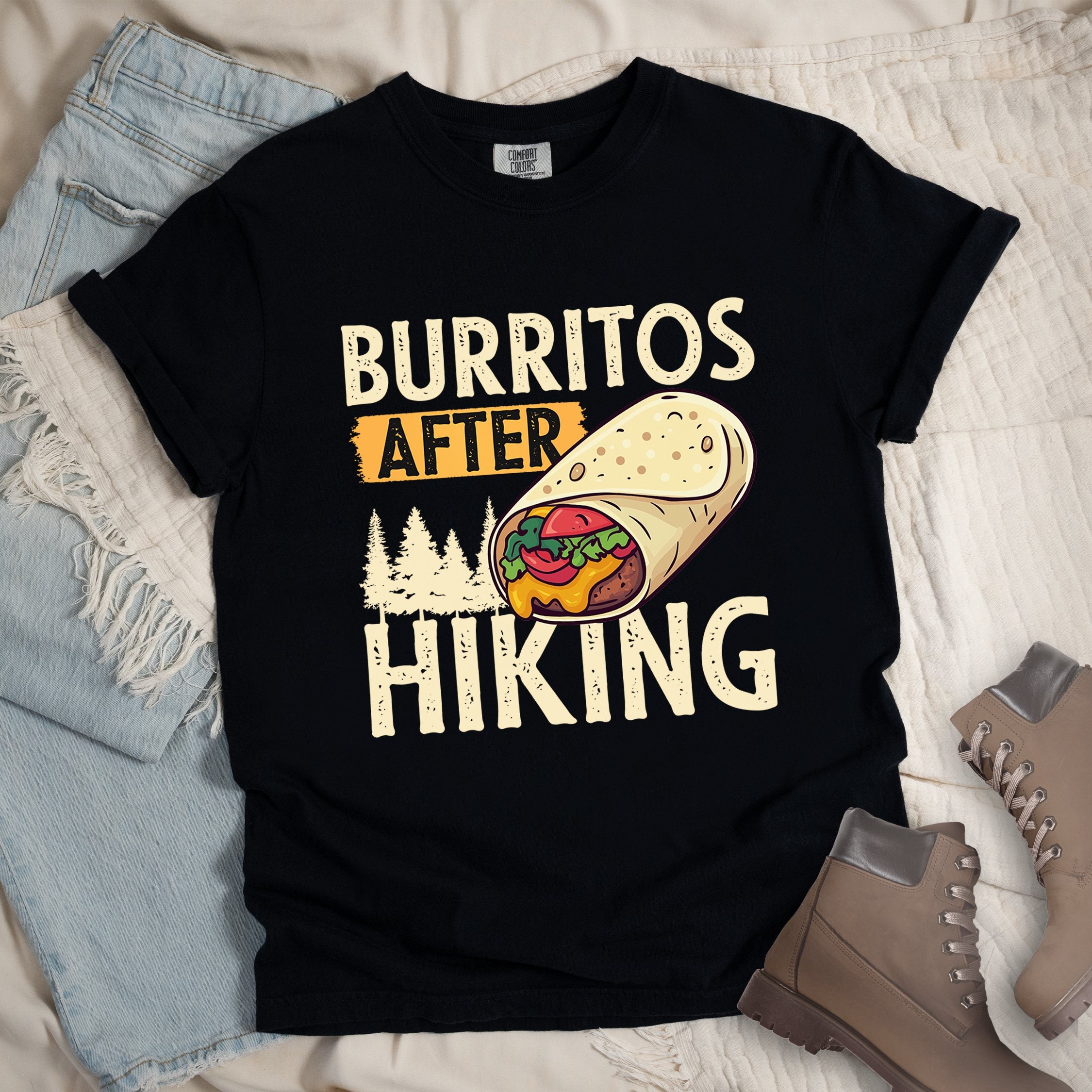 Black shirt with Hiking Design featuring the phrase “Burritos After Hiking” and an illustration of a stuffed burrito with cheese, vegetables, and trees in the background.