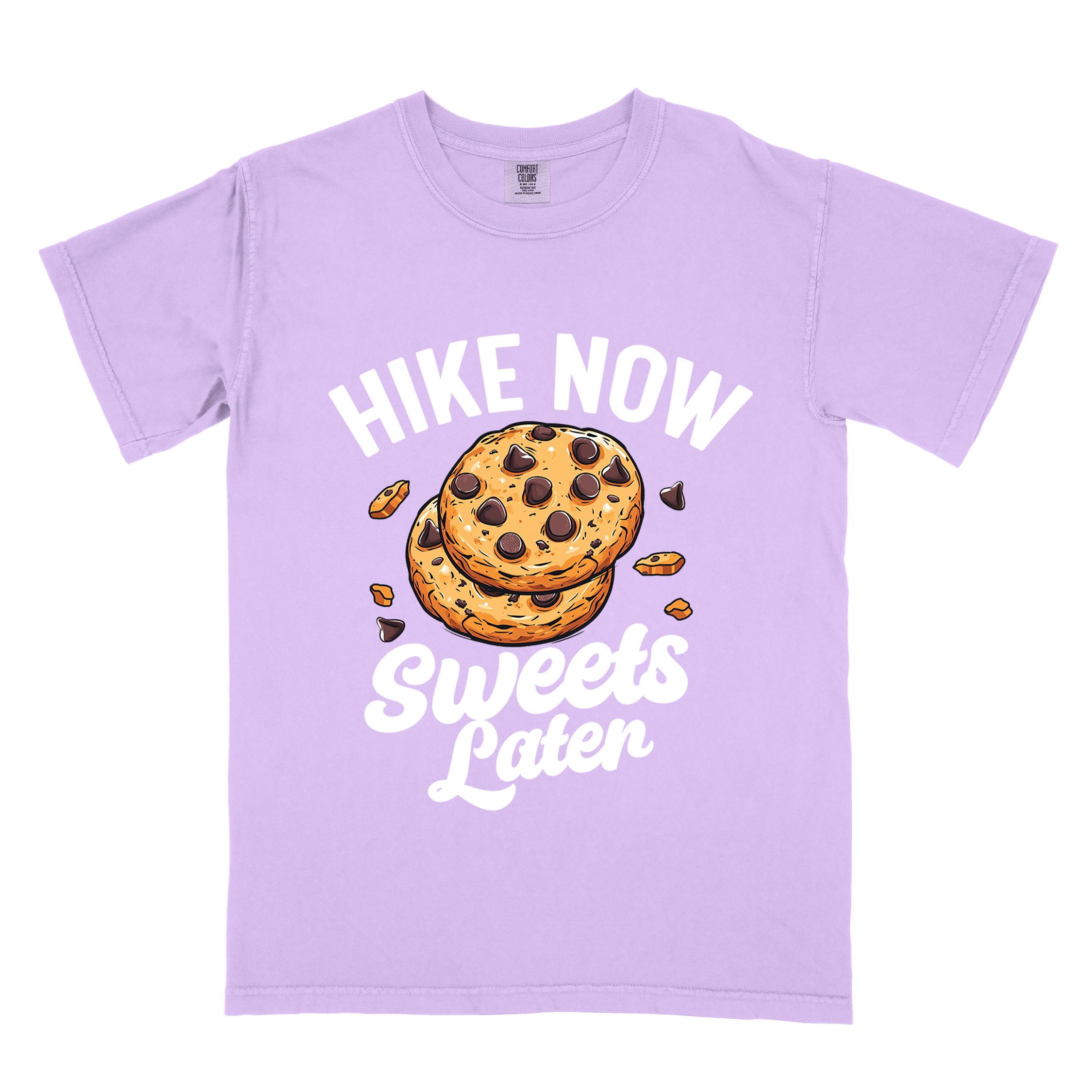 Orchid “Hike Now Sweets Later” colored vintage tee with bold and script typography, illustration of chocolate chip cookies with crumbs scattered around. Perfect for cookie lovers.