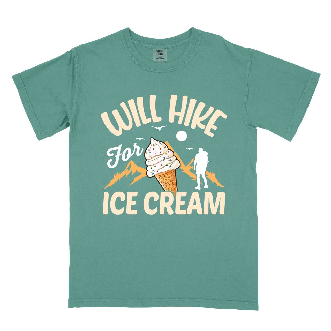 Light green Will Hike for Ice Cream statement tee with curved typography, script lettering, mountain peaks, hiker silhouette, and ice cream cone illustration on Comfort Colors shirt for dessert-loving outdoor enthusiasts