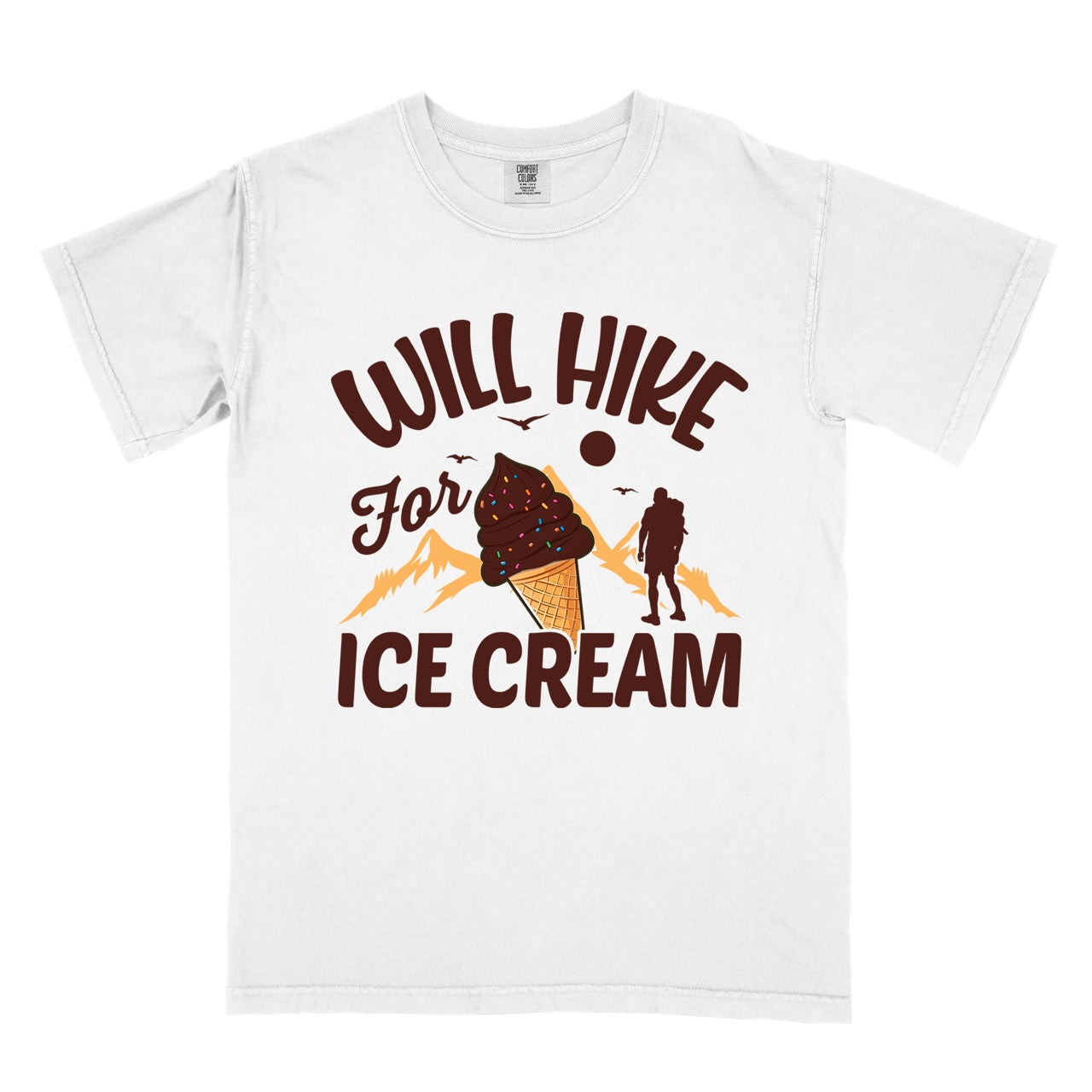 White Will Hike for Ice Cream statement tee with curved typography, script lettering, mountain peaks, hiker silhouette, and ice cream cone illustration on Comfort Colors shirt for dessert-loving outdoor enthusiasts