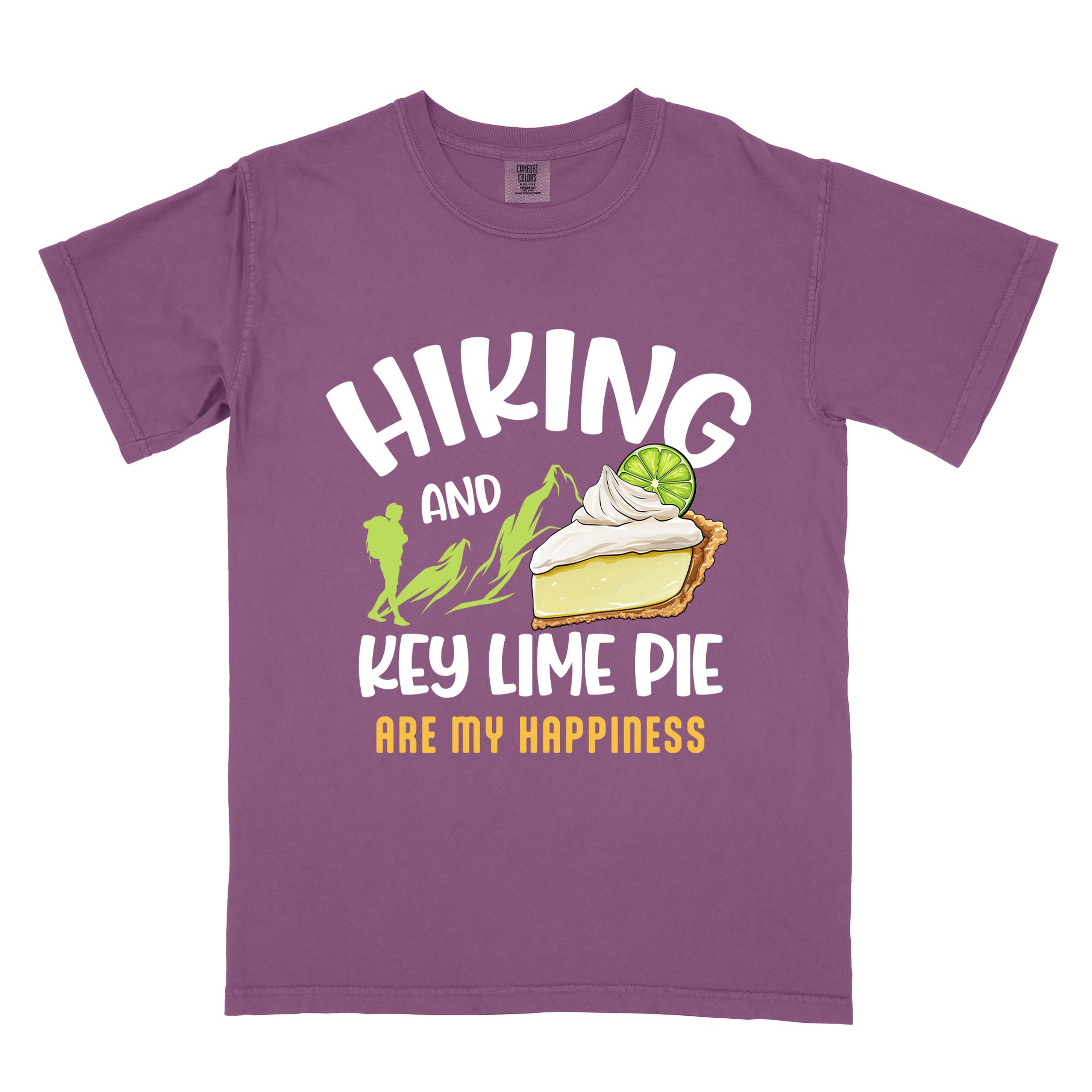 Berry "Hiking and key lime pie are my happiness" colored vintage tee with bold typography, mountains, birds, illustrated slice of key lime pie, and backpacker for pie lovers.