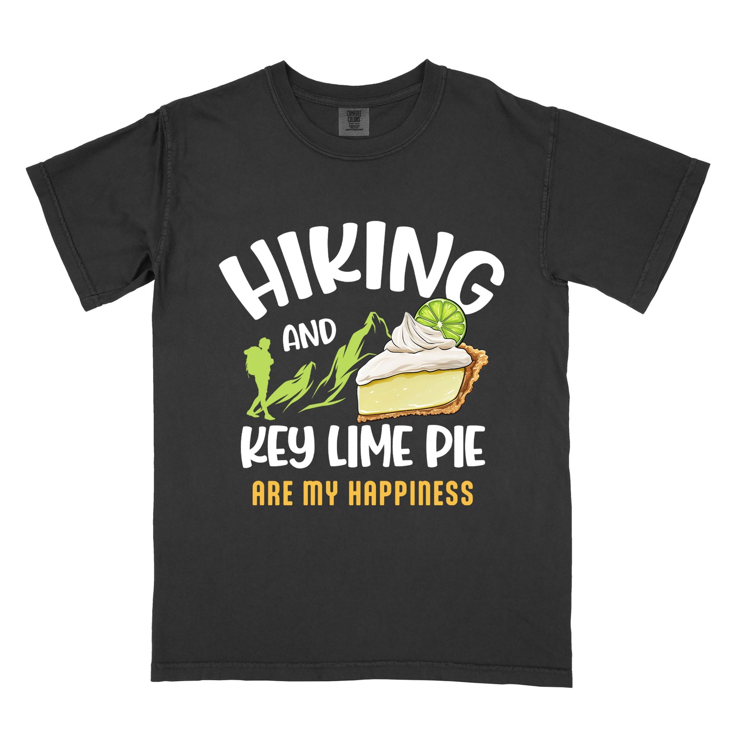Black t-shirt with text "HIKING AND KEY LIME PIE ARE MY HAPPINESS". "HIKING" appears in white arched letters at the top, "AND" in small white text, "KEY LIME PIE" in large white text in the middle, and "ARE MY HAPPINESS" in gold/yellow at the bottom. The design includes green mountain silhouettes with a hiker silhouette and an illustration of a slice of key lime pie with whipped cream and lime garnish in between "AND" and "KEY LIME PIE." 