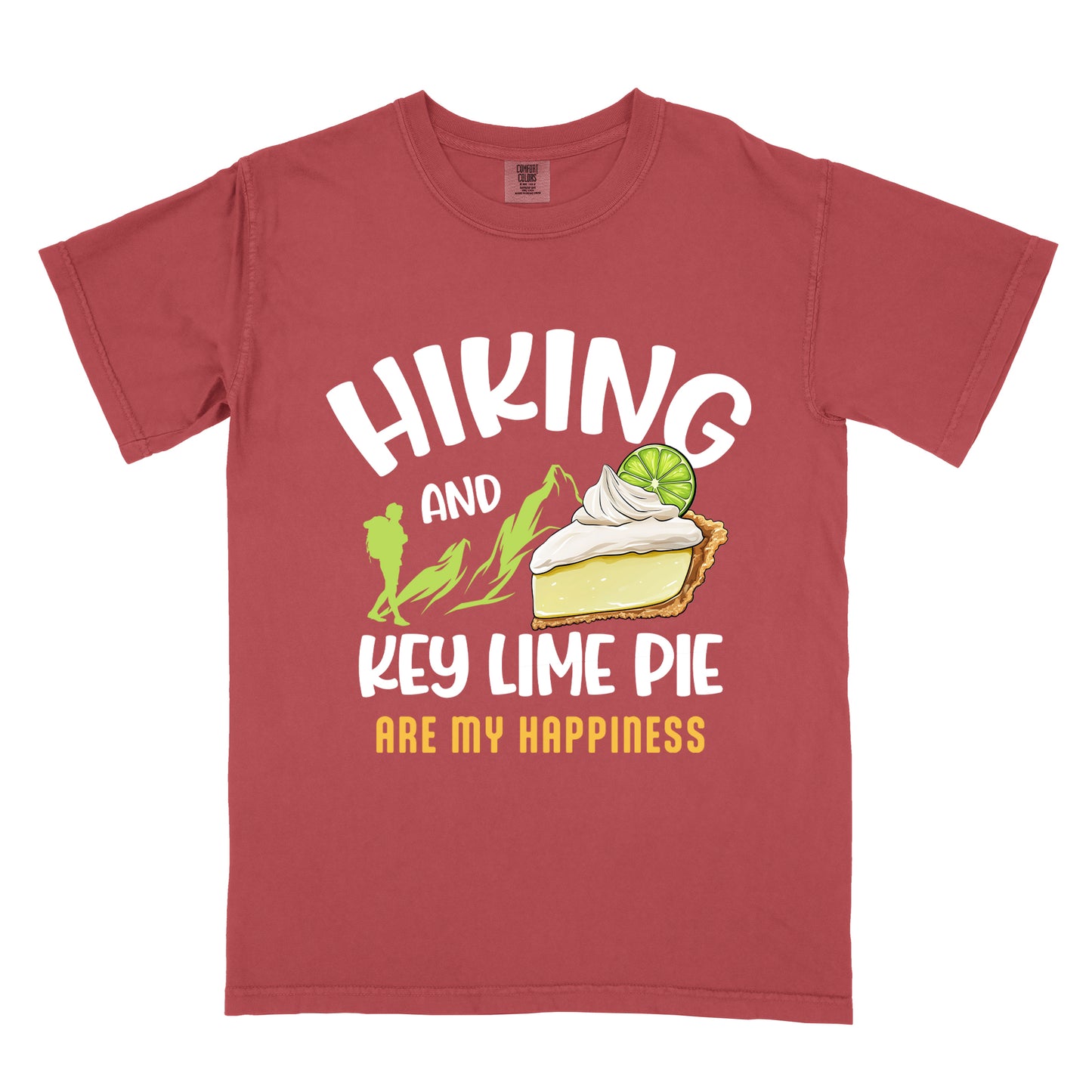 Crimson (Dark Pink) t-shirt with text "HIKING AND KEY LIME PIE ARE MY HAPPINESS". "HIKING" appears in white arched letters at the top, "AND" in small white text, "KEY LIME PIE" in large white text in the middle, and "ARE MY HAPPINESS" in gold/yellow at the bottom. The design includes green mountain silhouettes with a hiker silhouette and an illustration of a slice of key lime pie with whipped cream and lime garnish in between "AND" and "KEY LIME PIE." 
