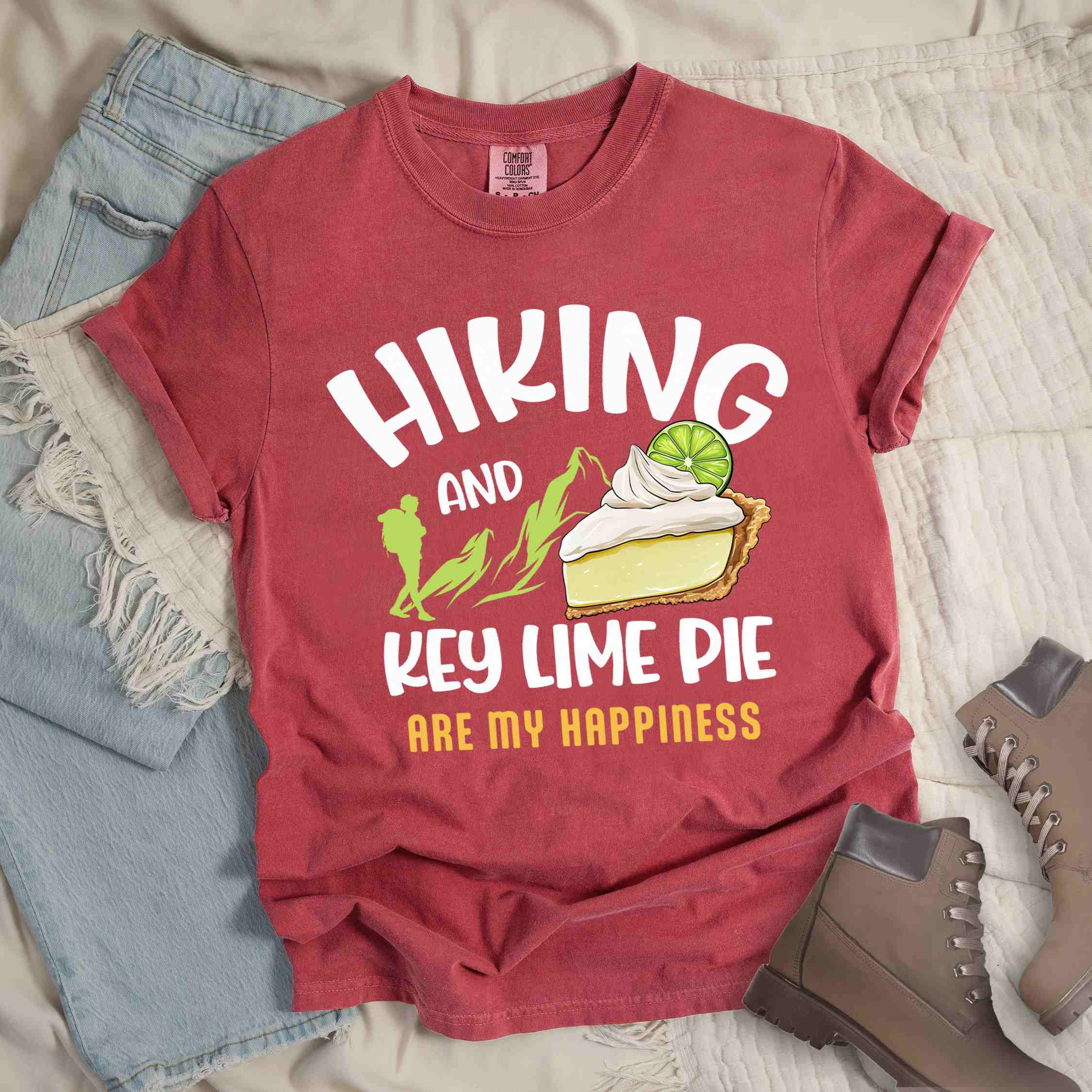 Crimson "Hiking and key lime pie are my happiness" colored vintage tee with bold typography, mountains, birds, illustrated slice of key lime pie, and backpacker for pie lovers.