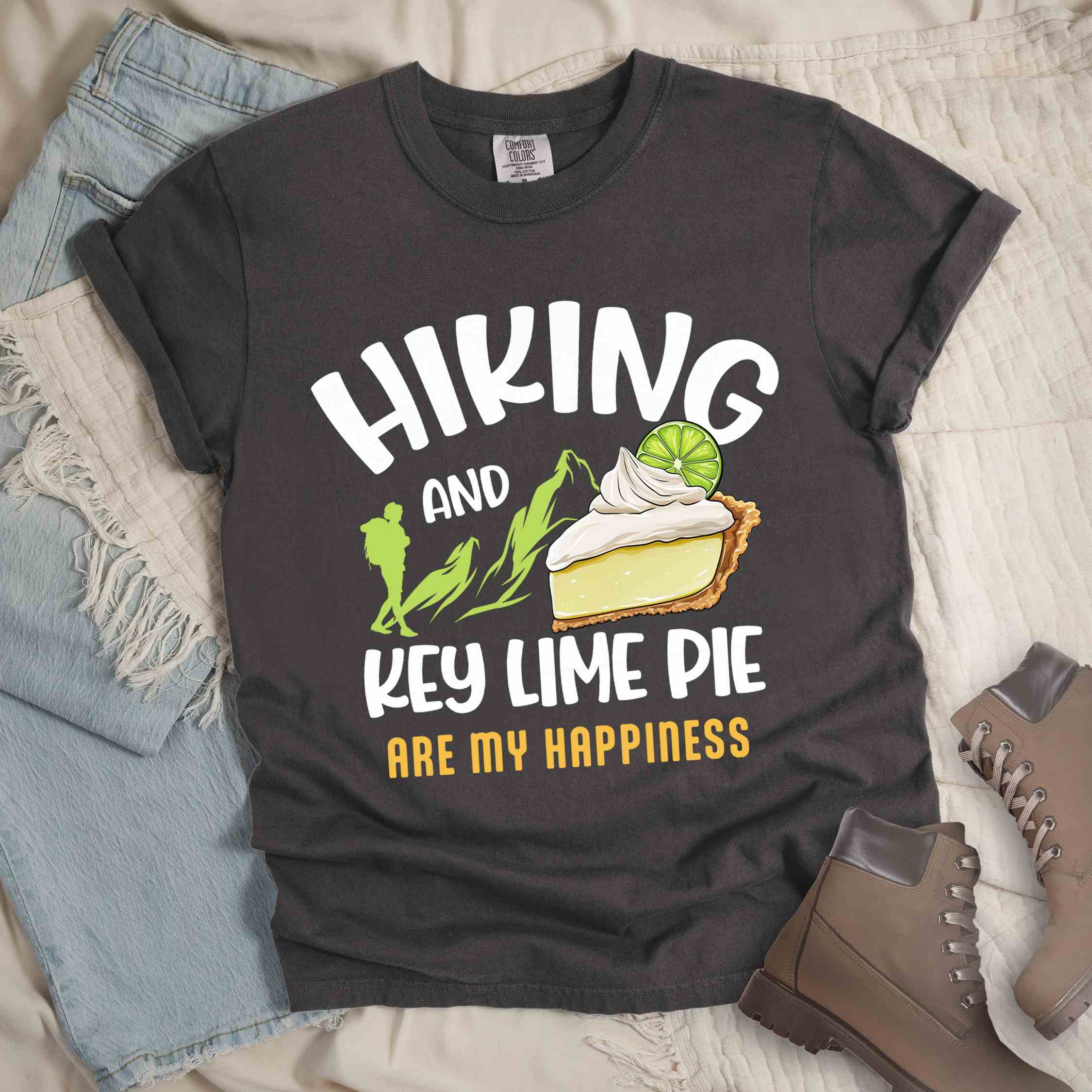Pepper "Hiking and key lime pie are my happiness" colored vintage tee with bold typography, mountains, birds, illustrated slice of key lime pie, and backpacker for pie lovers.