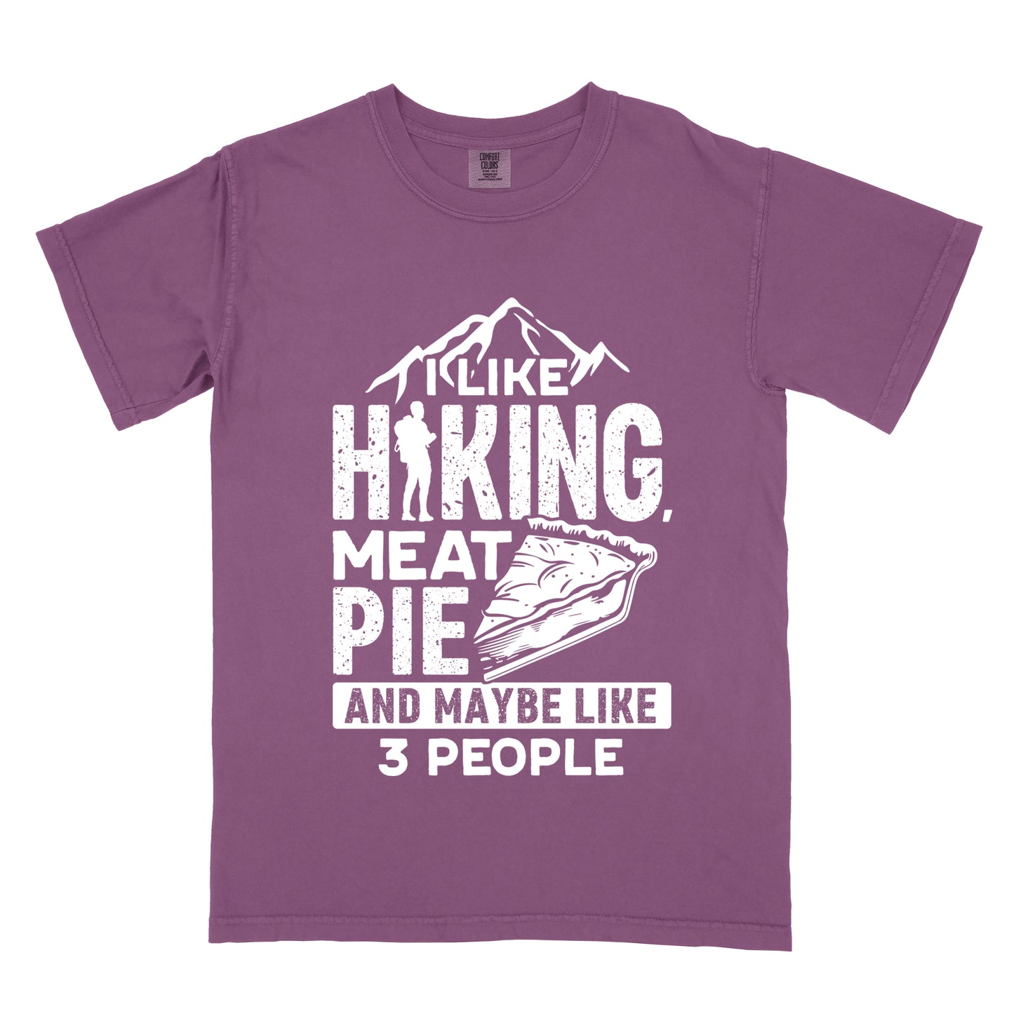 Berry (Dark Violet) t-shirt with white distressed text reading "I LIKE HIKING, MEAT PIE AND MAYBE LIKE 3 PEOPLE". Mountain silhouettes appear above "I LIKE". The letter "I" in "HIKING" is replaced with a hiker silhouette. Next to "MEAT PIE" is an illustration of a slice of pie. All text and graphics are in white with a weathered, vintage appearance. The design combines outdoor activities, food preferences, and introvert humor.