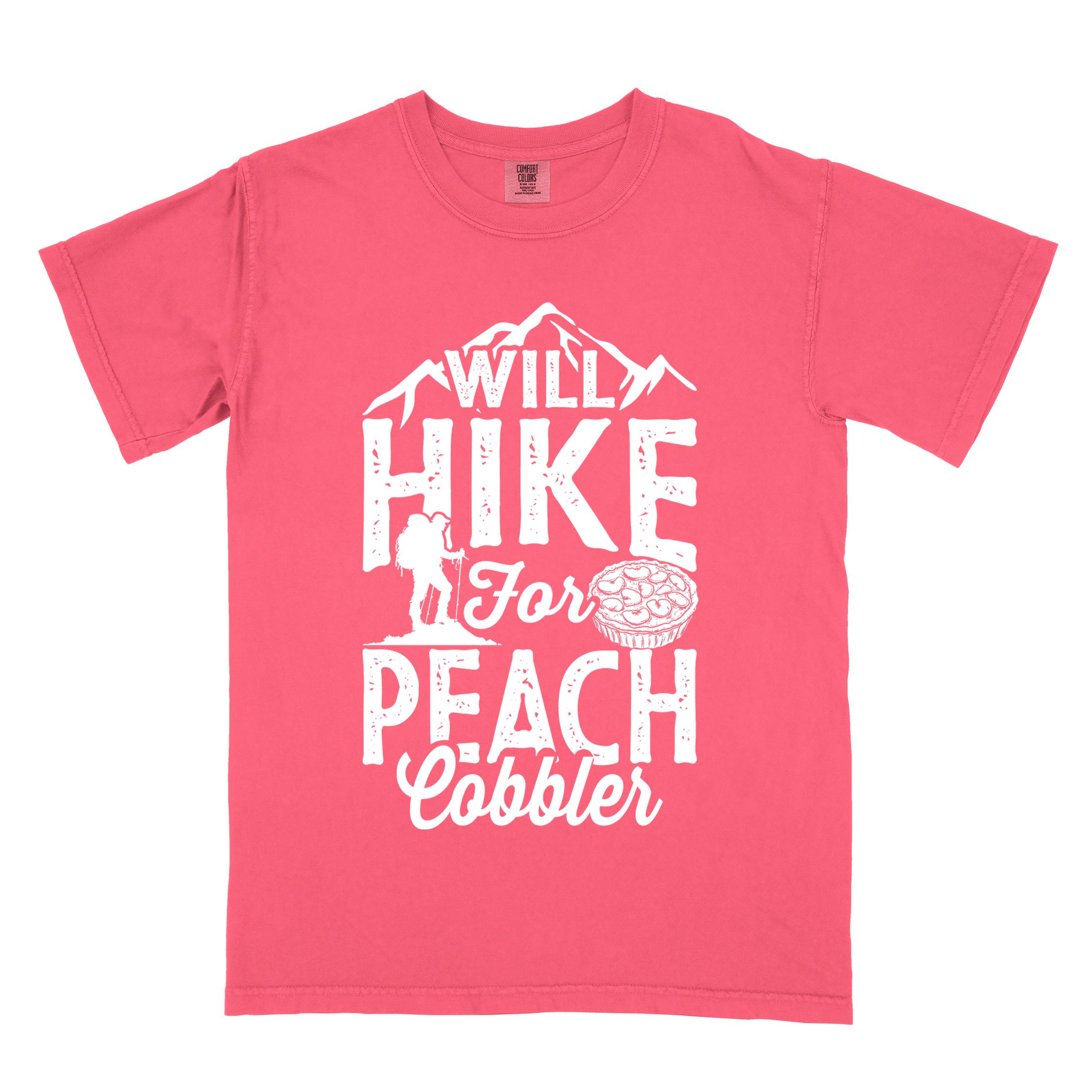 Watermelon "Will hike for peach cobbler" colored vintage tee with bold typography, mountain, birds, illustrated peach cobbler, and backpacker looking for sweet treats.