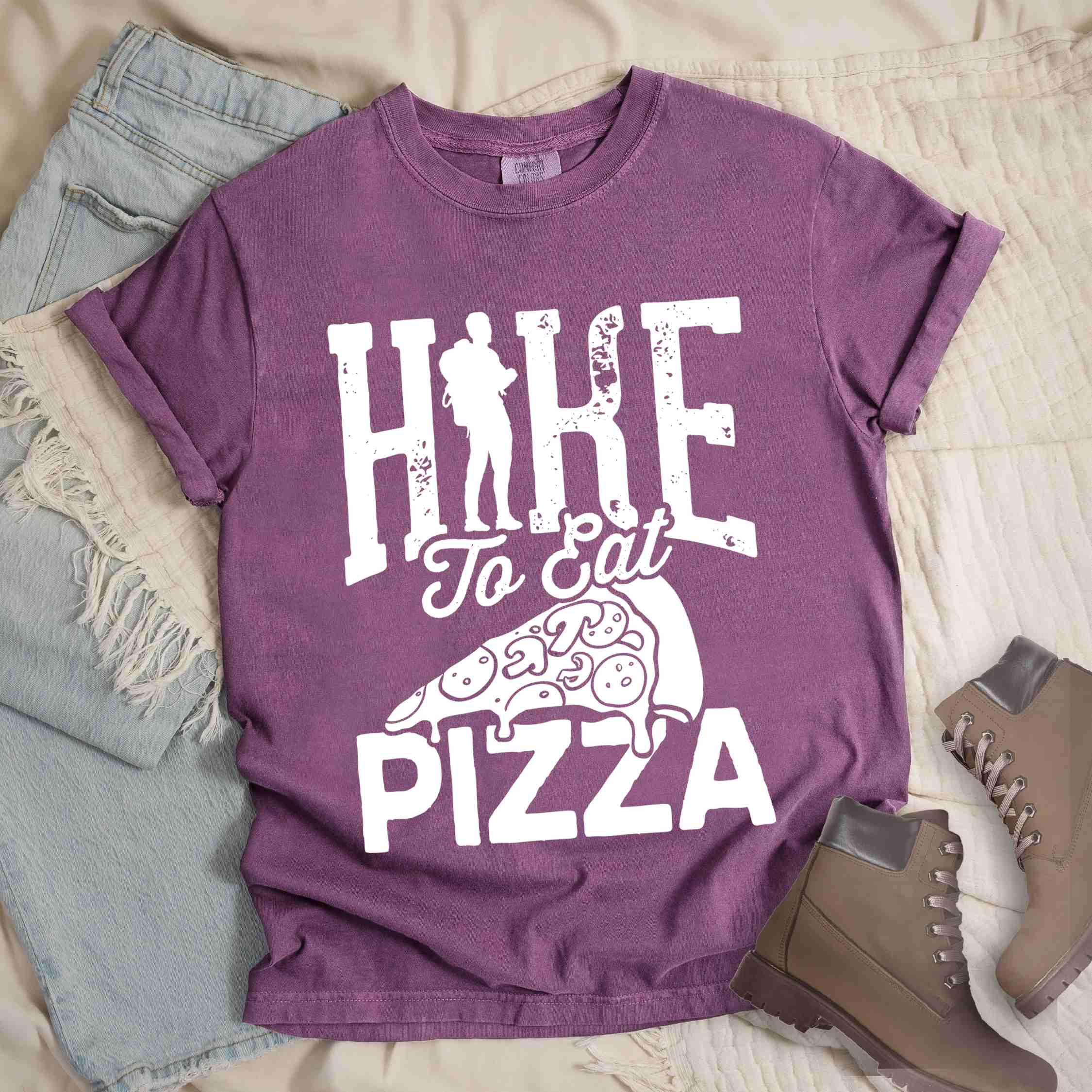 Berry "Hike to eat Pizza" colored vintage tee with bold typography, birds, mountains, illustrated pizza slice, and backpacker for pizza lover.