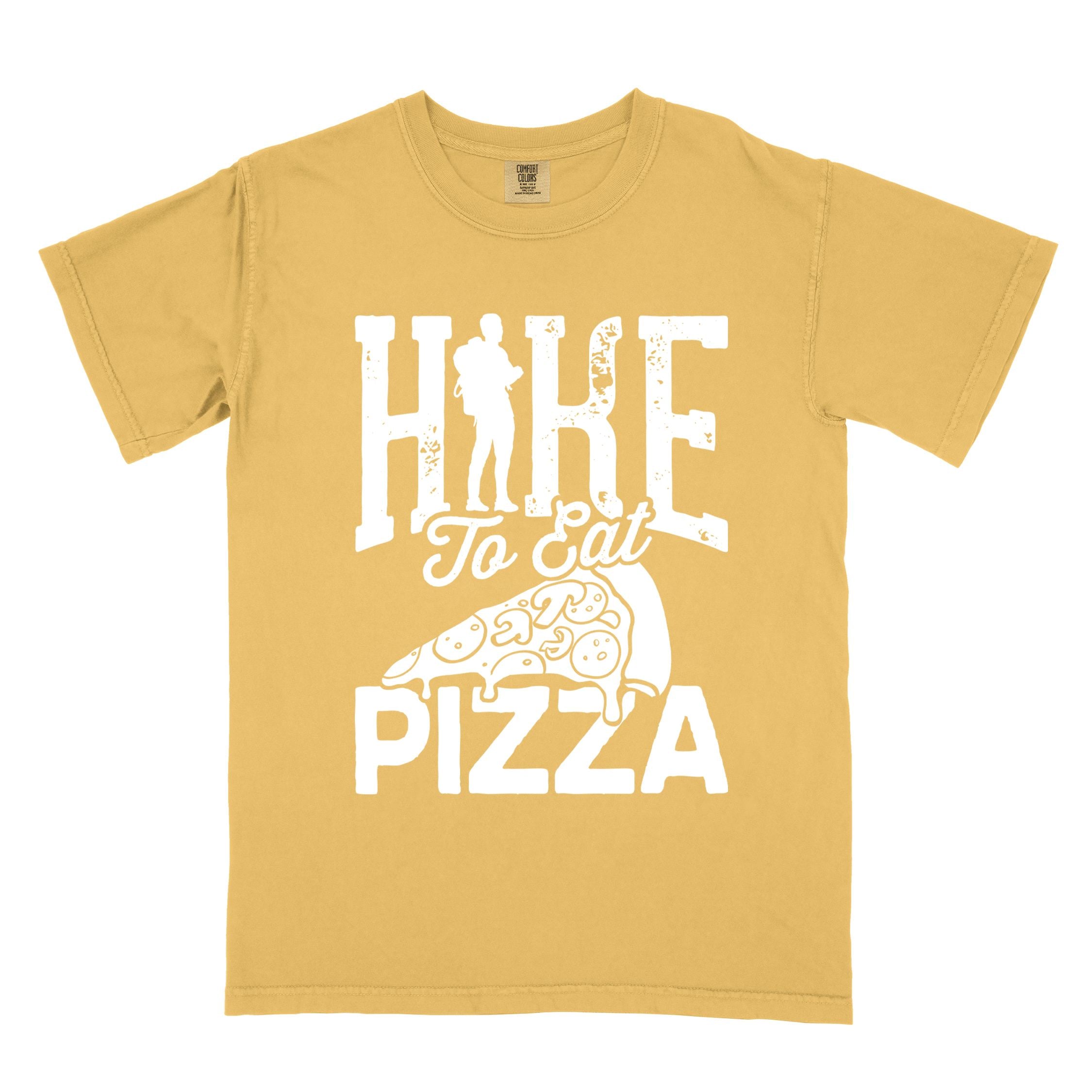 Mustard "Hike to eat Pizza" colored vintage tee with bold typography, birds, mountains, illustrated pizza slice, and backpacker for pizza lover.