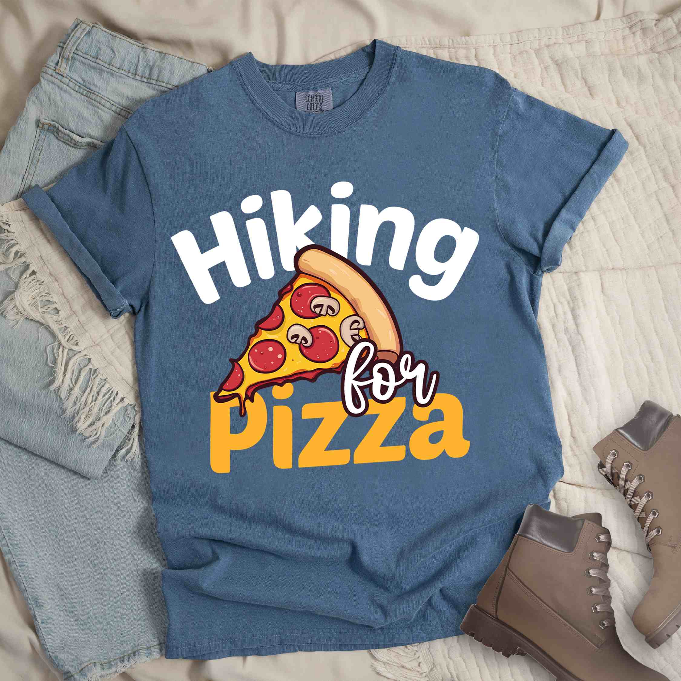 blue jean "Hiking for pizza" colored vintage tee with bold typography, illustrated pizza slice, and backpacker for pizza lover.