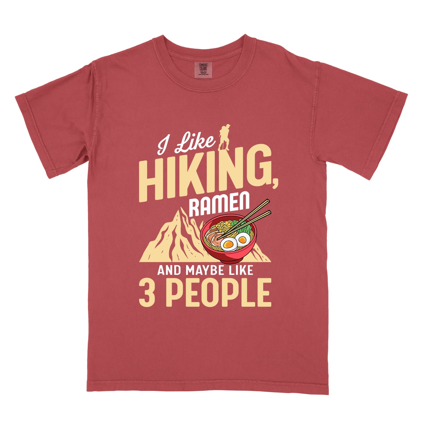 Crimson (Dark Pink) t-shirt with mixed text reading "I Like HIKING, RAMEN AND MAYBE LIKE 3 PEOPLE". "I Like" in white script at top with small gold hiker silhouette, "HIKING," in large gold letters, "RAMEN" in white, and "AND MAYBE LIKE 3 PEOPLE" in white and gold. Features a colorful illustration of a red ramen bowl with eggs, noodles and chopsticks, positioned above a gold mountain silhouette.