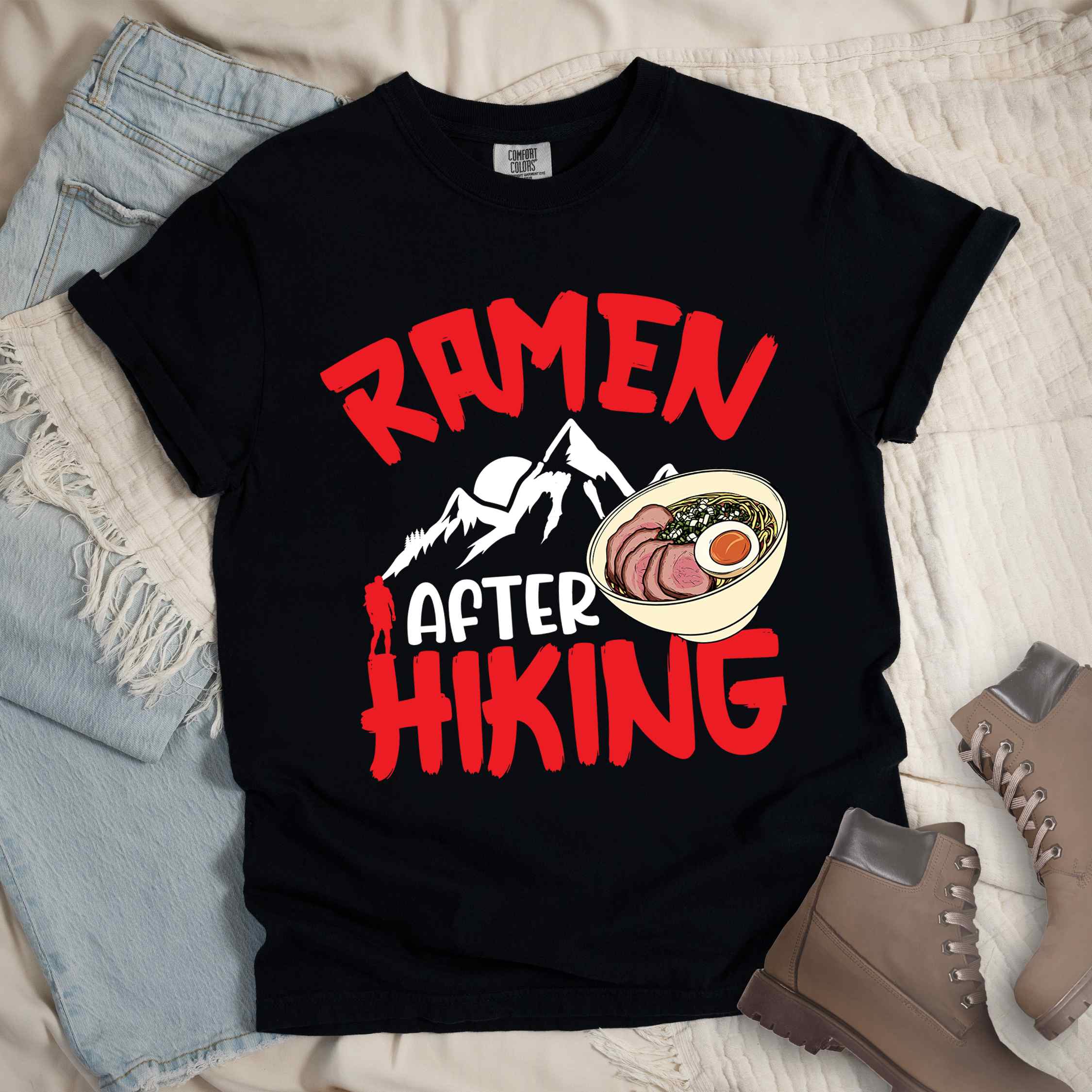 Black “Ramen after hiking” colored vintage tee with bold text, mountain, Illustration of hot ramen. Perfect tee for a foodie craving for a bowl of ramen