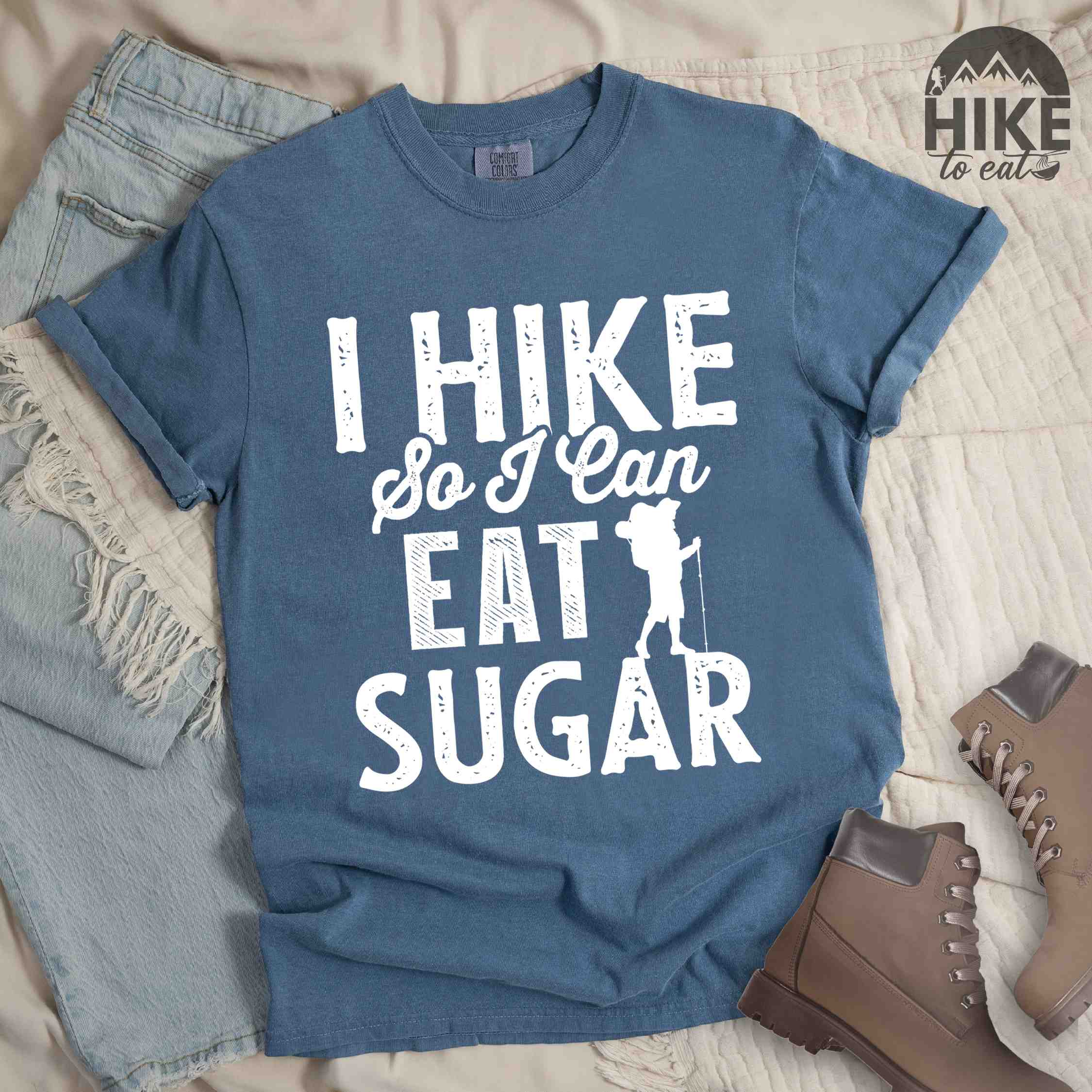 Blue jean "I hike so I can eat sugar" colored vintage tee with bold typography, and backpacker with a sweet tooth.