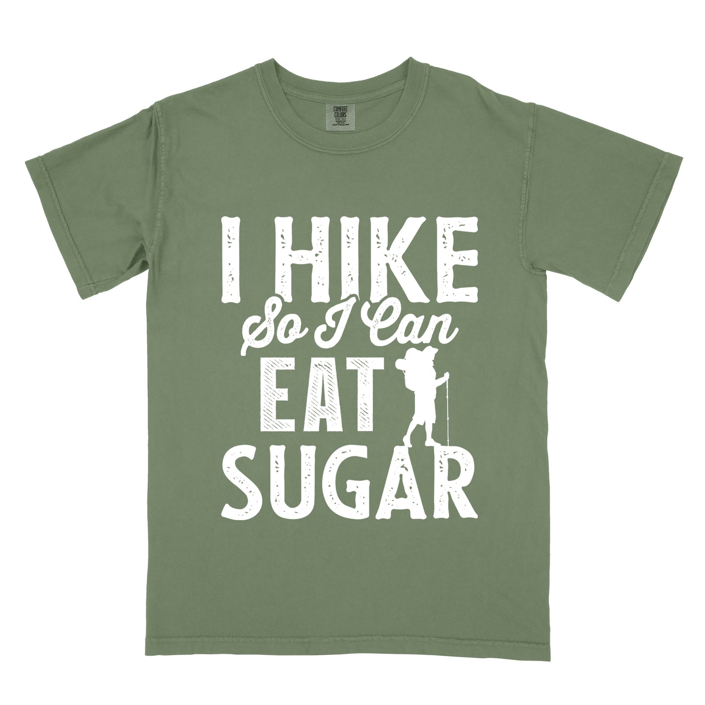 Moss (Dark Green) t-shirt with white distressed text reading "I HIKE So I Can EAT SUGAR". "I HIKE" appears in large block letters at the top, "So I Can" in script in the middle, and "EAT SUGAR" in block letters at the bottom. A small silhouette of a hiker with backpack and walking stick is positioned next to the word "EAT" and above "SUGAR".