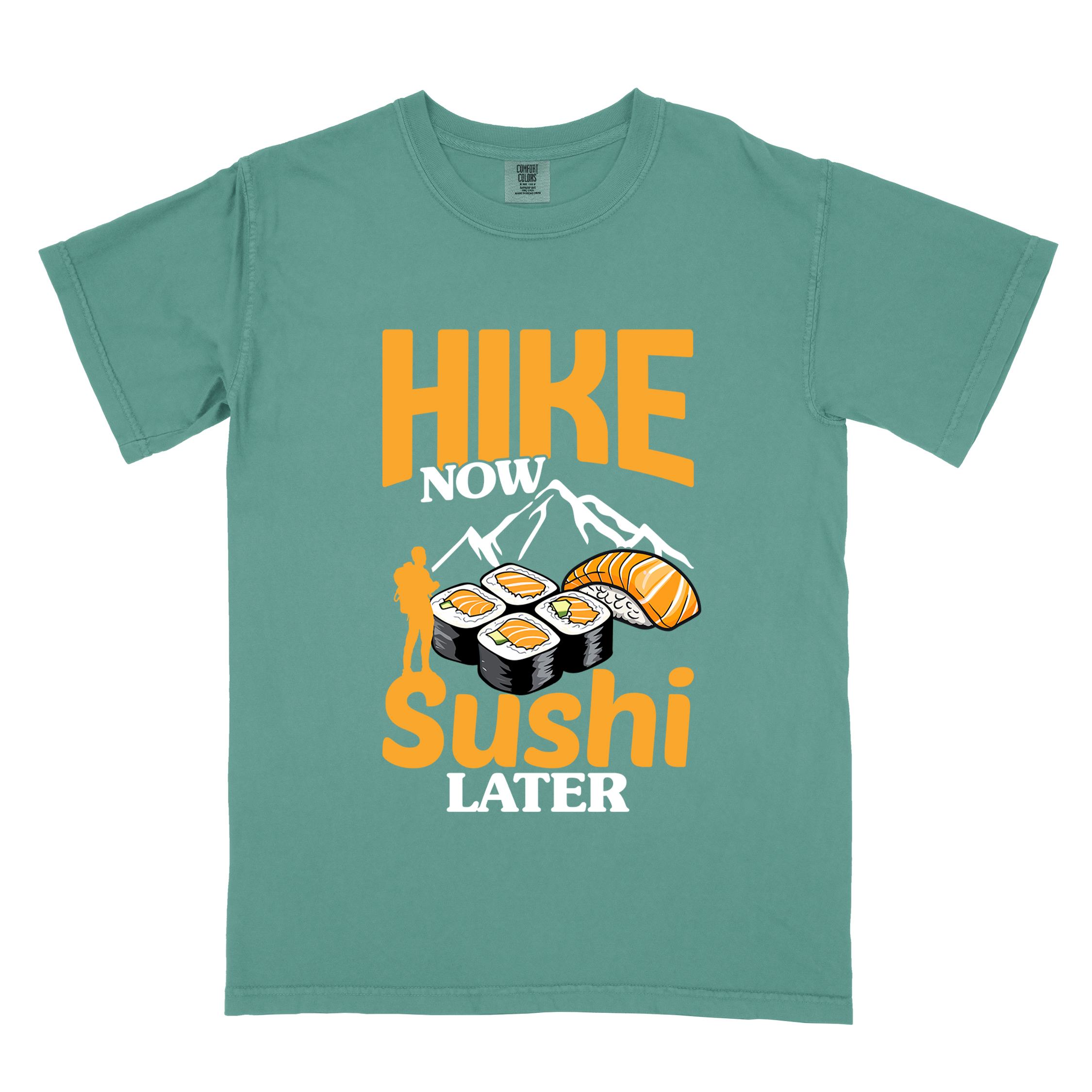 Light green "Hike now sushi later" colored vintage tee with bold typography, birds, mountains, illustrated sushi platter, and backpacker for sushi lovers.