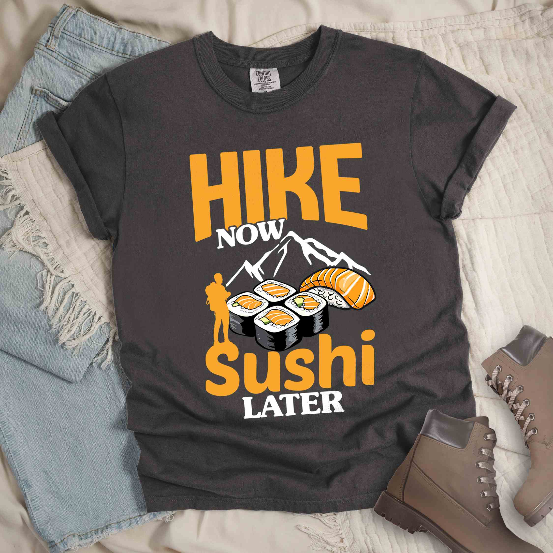 Pepper "Hike now sushi later" colored vintage tee with bold typography, birds, mountains, illustrated sushi platter, and backpacker for sushi lovers.