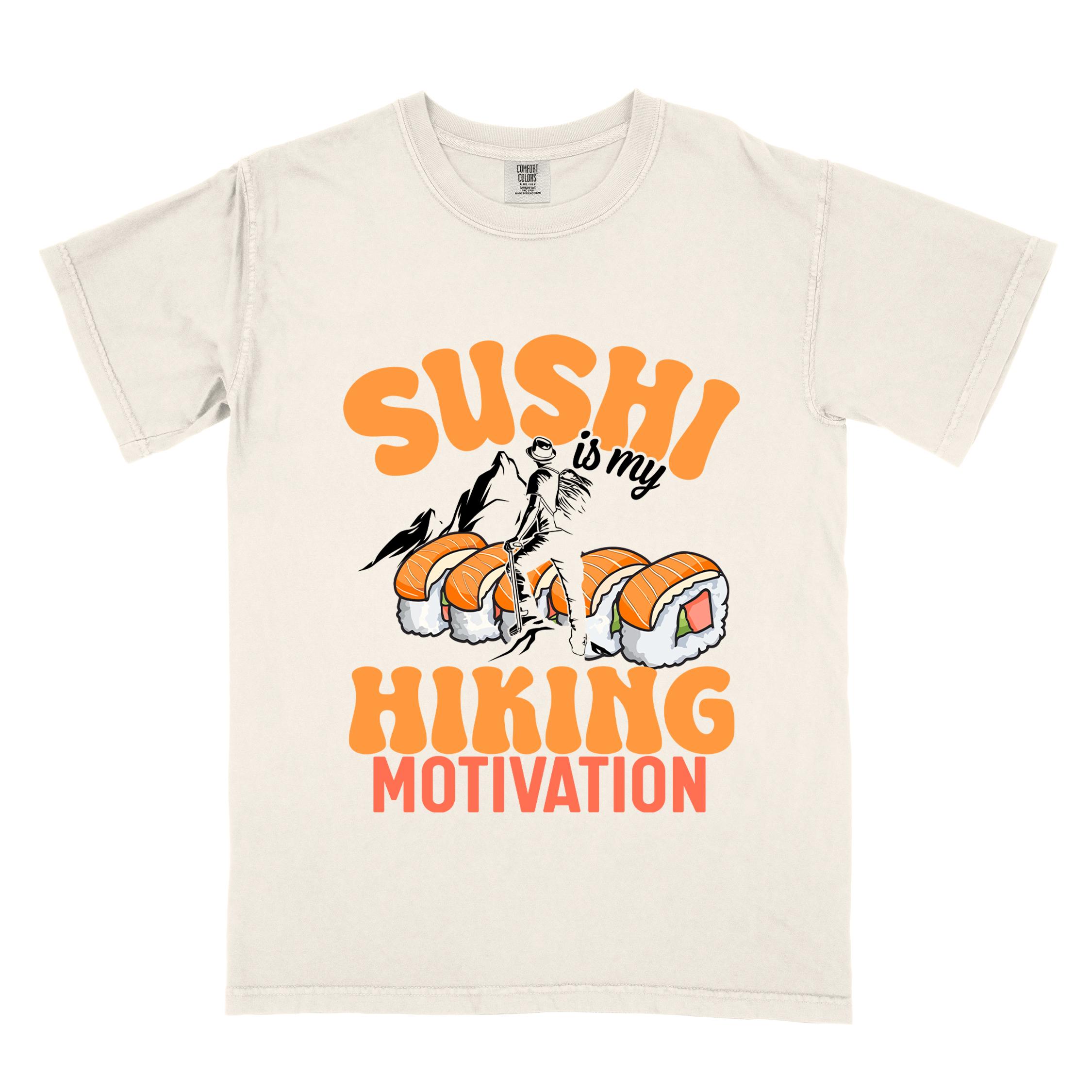 Ivory "sushi is my hiking motivation" colored vintage tee with bold typography, birds, mountains, illustrated sushi platter, and backpacker for sushi lovers.