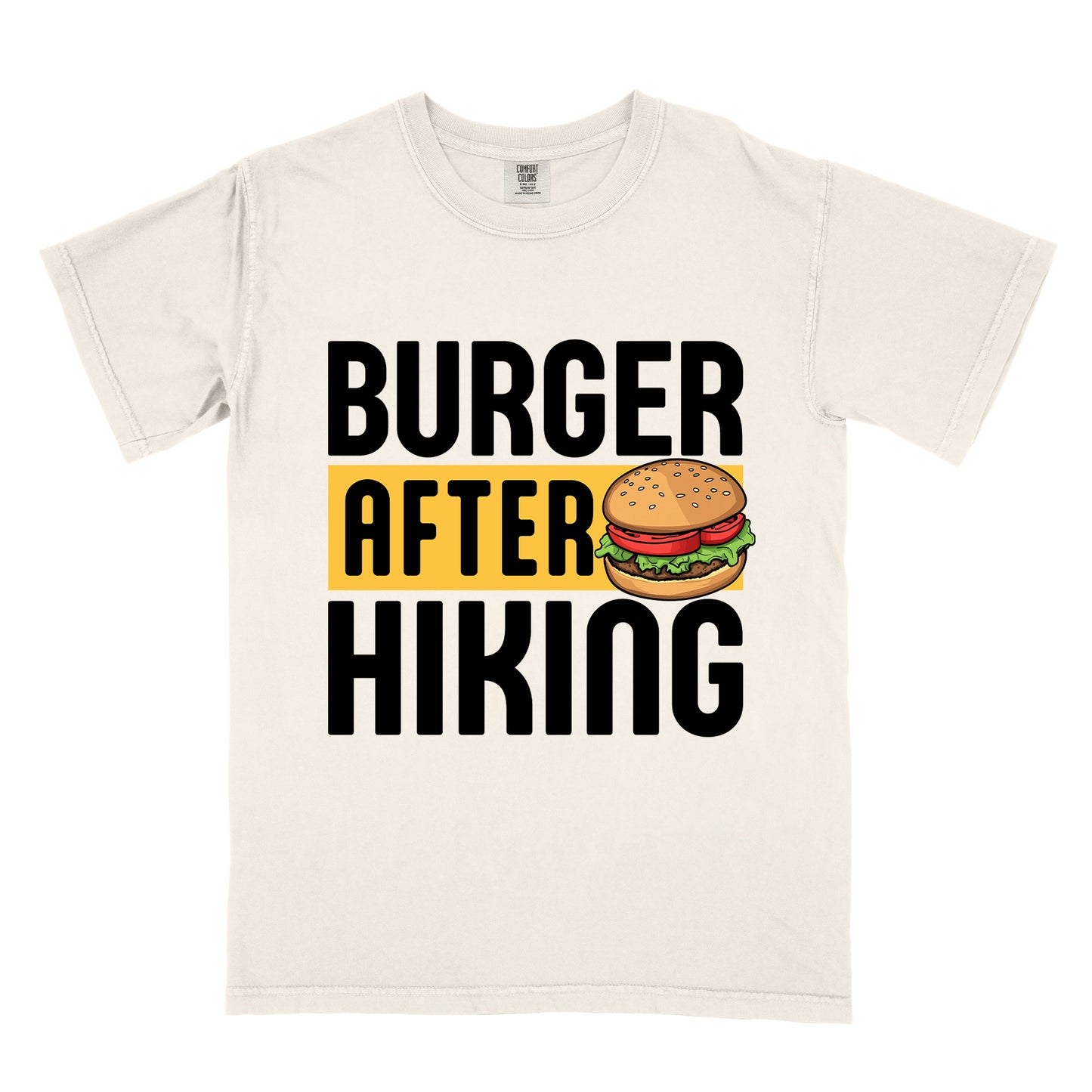 Ivory (Cream White) t-shirt with bold text reading "BURGER AFTER HIKING". "BURGER" appears in large black letters at the top, "AFTER" in black text on a yellow rectangular background in the middle, and "HIKING" in large black letters at the bottom. Features a detailed illustration of a hamburger with sesame seed bun, lettuce, tomato and patty next to the word "AFTER". 