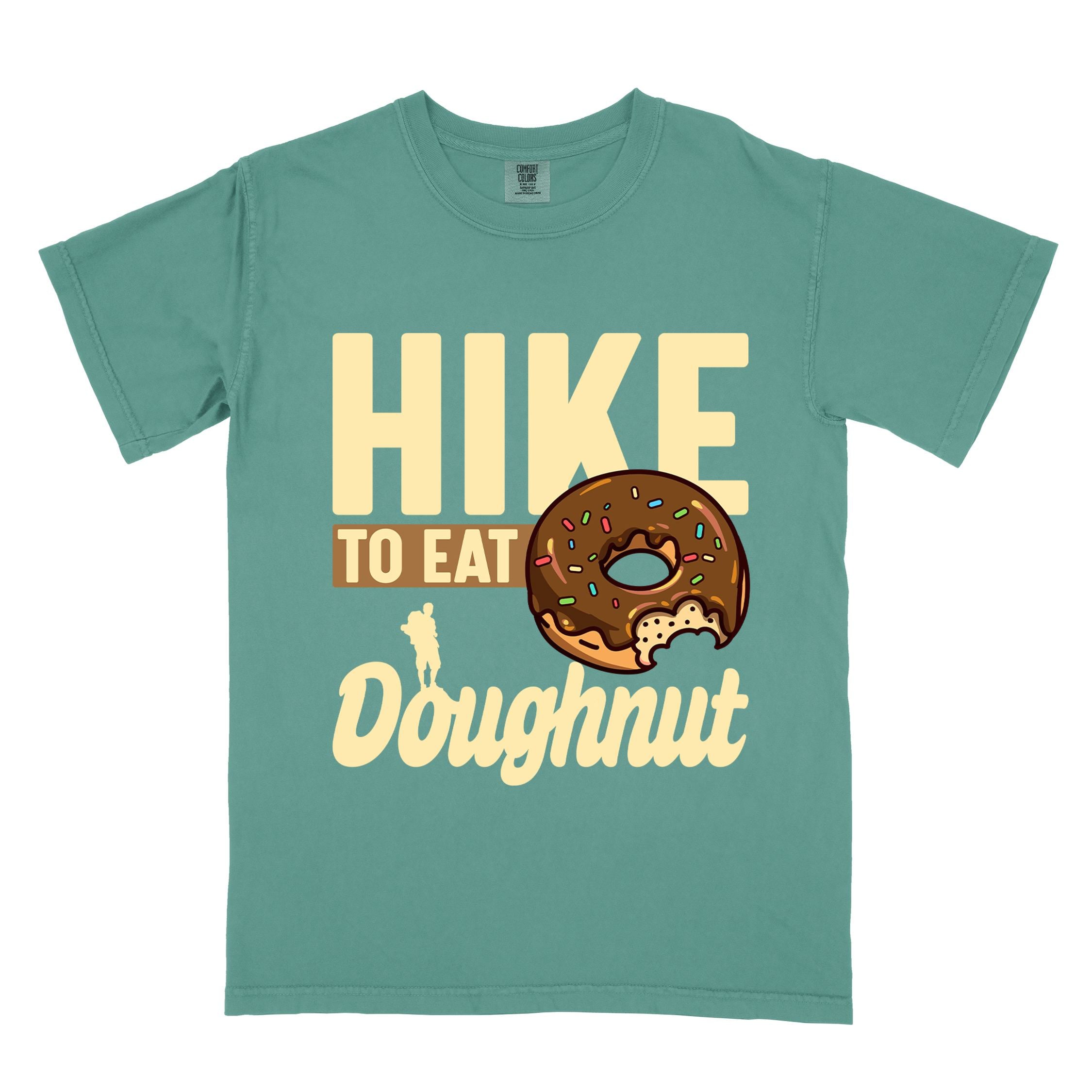 Light green "Hike to eat doughnut" colored vintage tee with bold typography, birds, mountains, illustrated baked chocolate glazed donut, and backpacker for donut lovers.