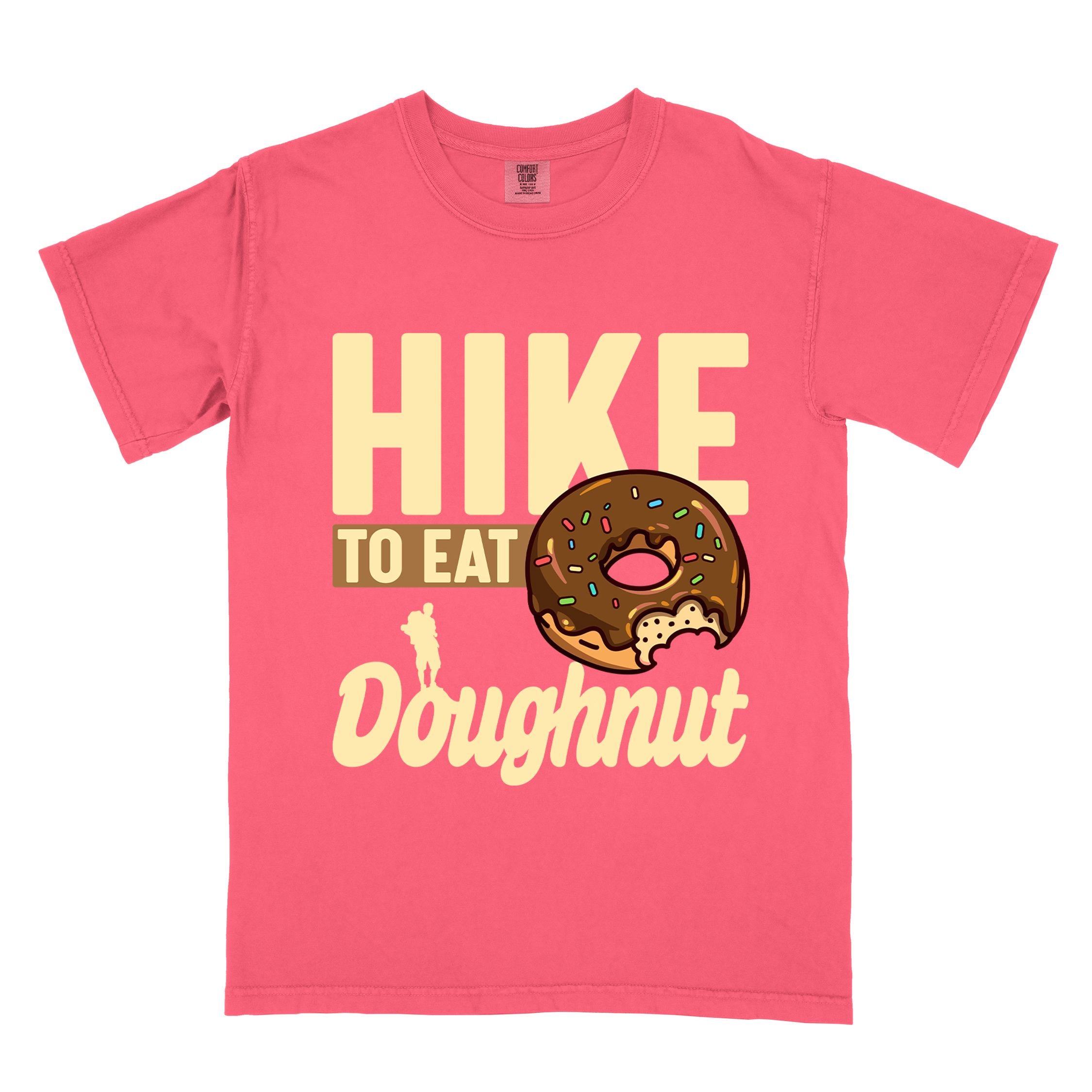 Watermelon "Hike to eat doughnut" colored vintage tee with bold typography, birds, mountains, illustrated baked chocolate glazed donut, and backpacker for donut lovers.