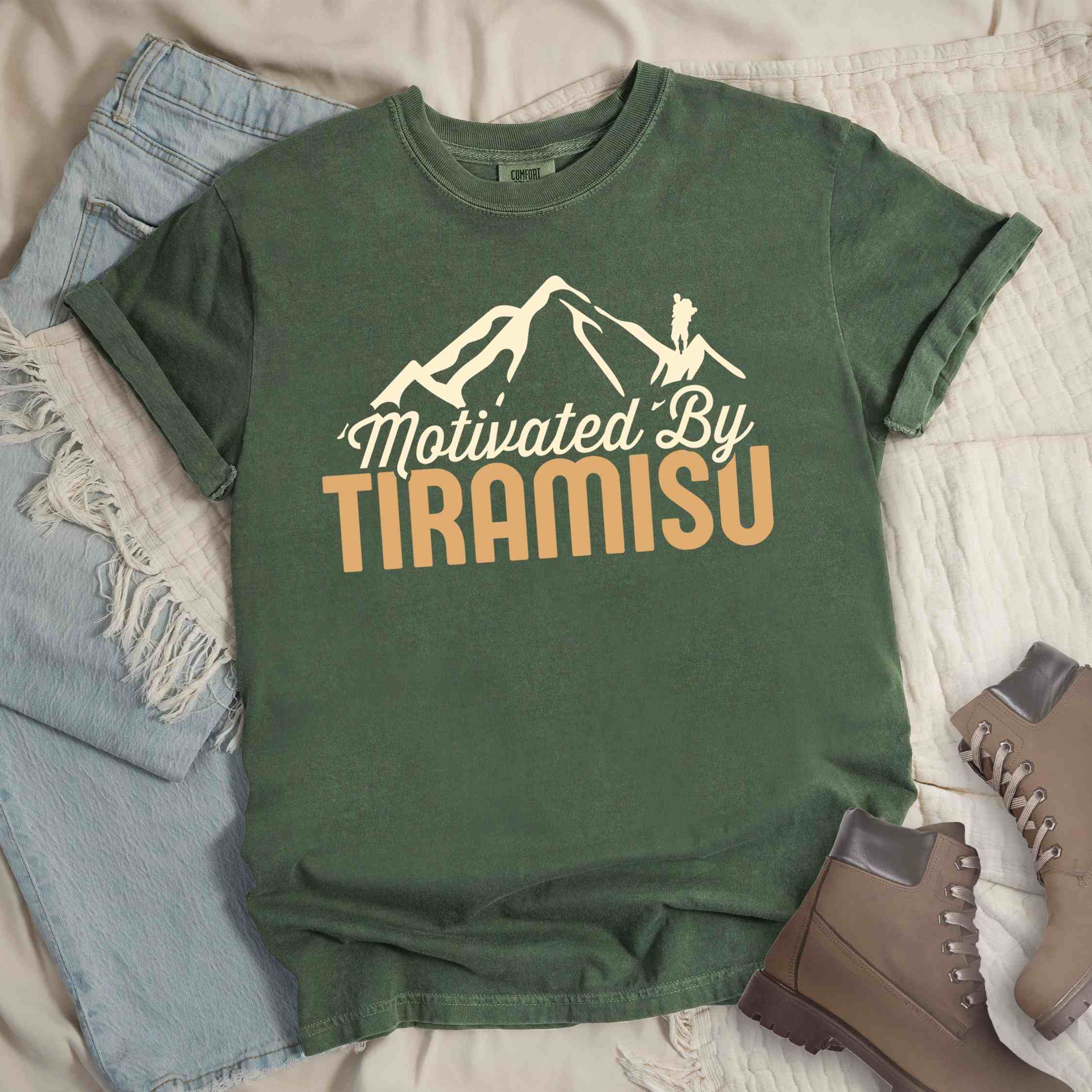 Moss "Motivated by Tiramisu" colored vintage tee with bold typography, mountains, and backpackers with a sweet tooth.