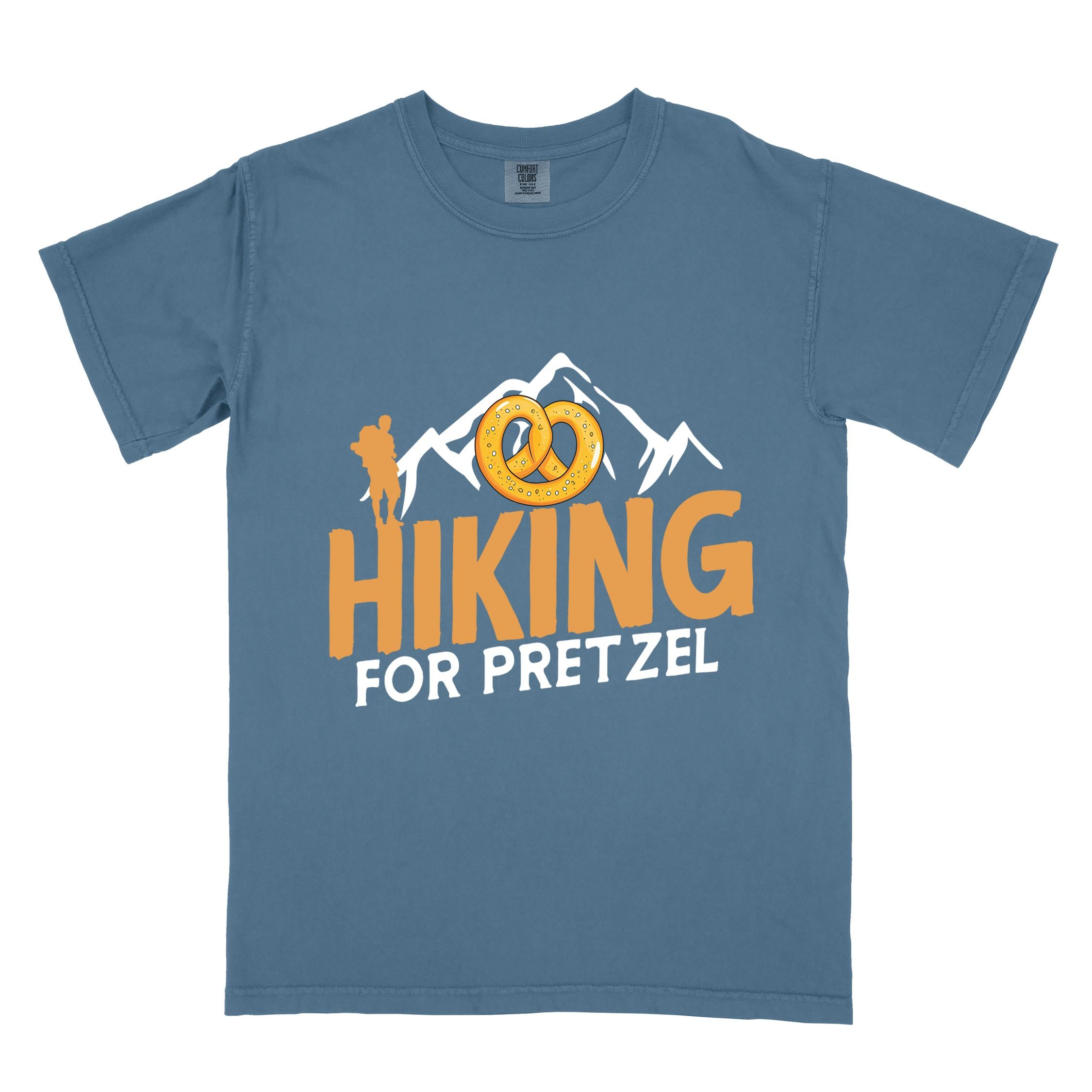 Blue jean "Hiking for pretzel" colored vintage tee with bold typography, mountains, birds, and illustrated pretzel for baked pretzel lovers