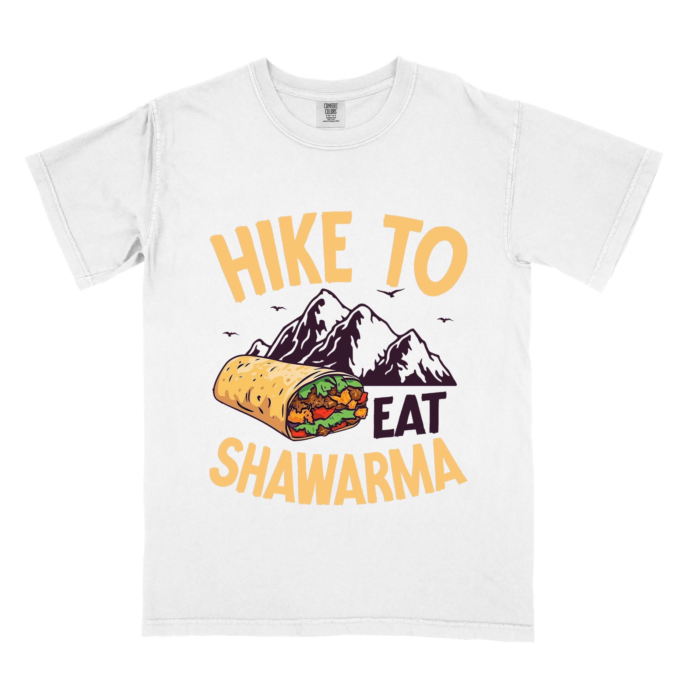 White "Hike to Eat Shawarma" colored vintage tee with bold typography, mountains, birds, and illustrated shawarma, and backpackers for shawarma lovers.