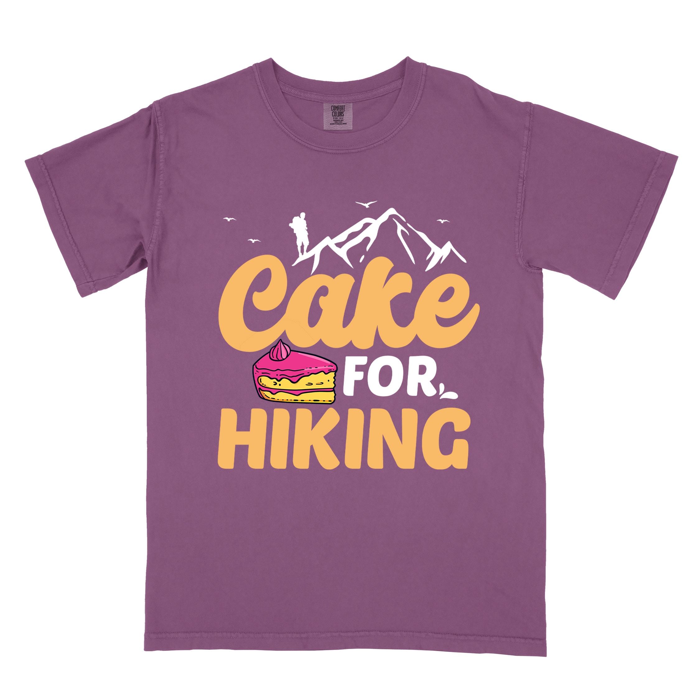 Berry "Cake for Hiking" colored vintage tee with bold typography, mountains, illustrated a slice of cake, and backpackers with a sweet tooth.