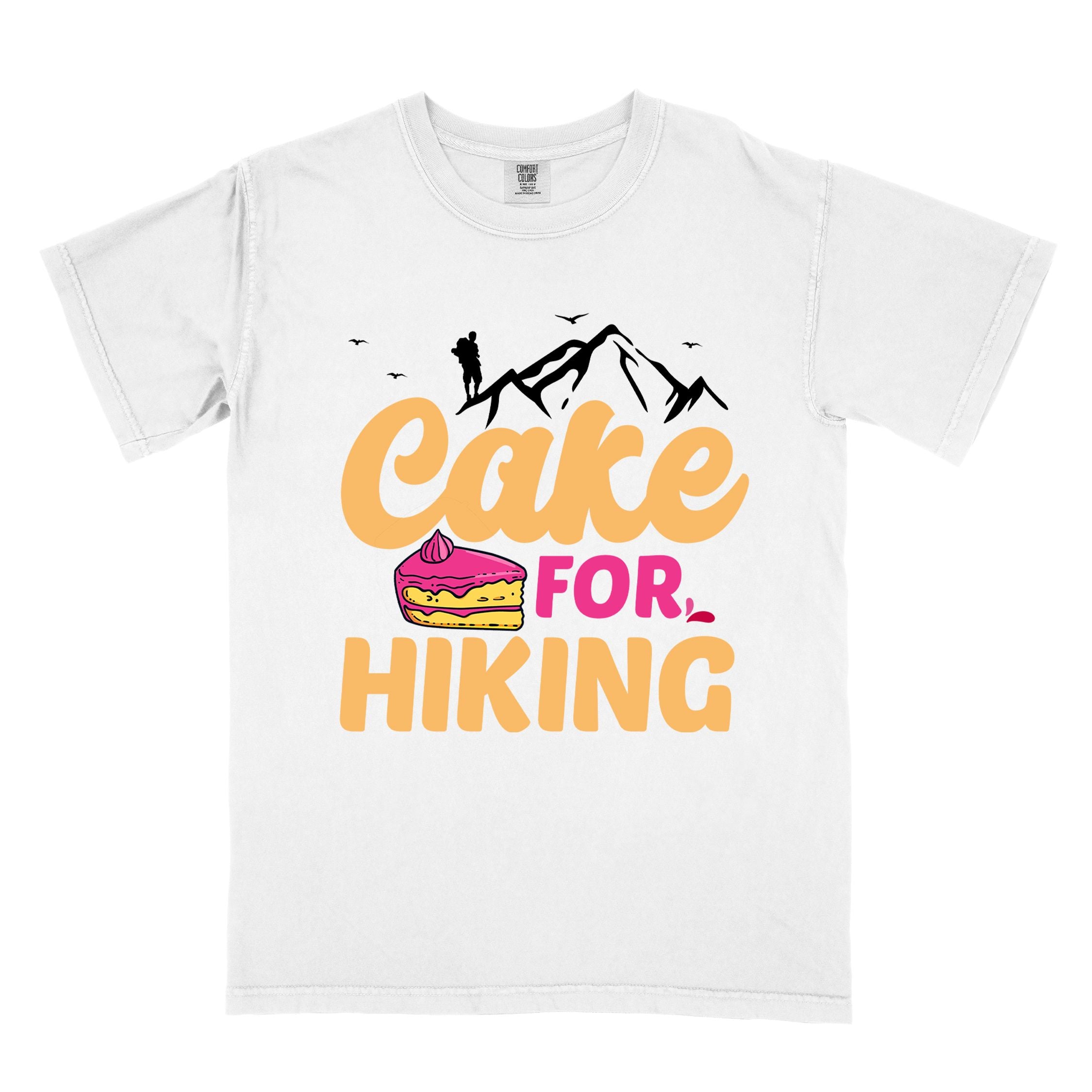 White "Cake for Hiking" colored vintage tee with bold typography, mountains, illustrated a slice of cake, and backpackers with a sweet tooth.