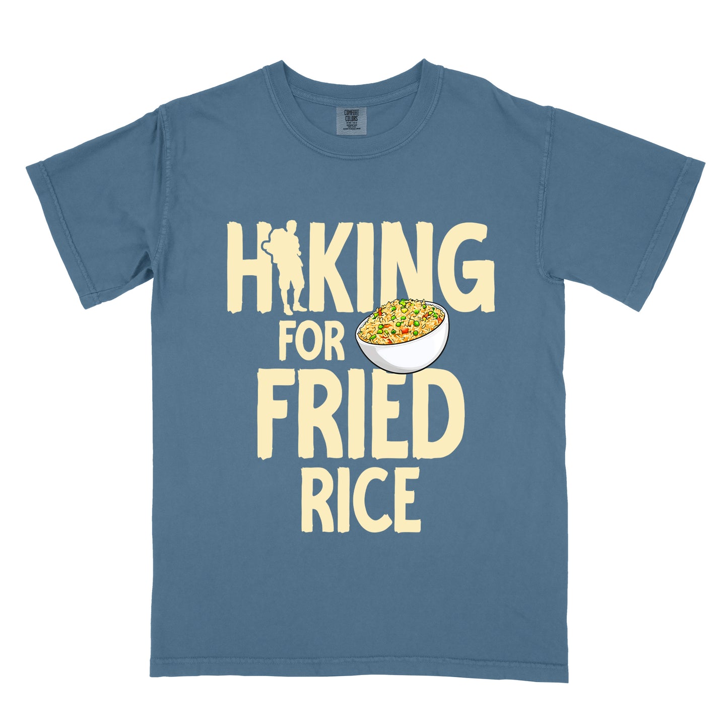 Blue Jean (Denim Blue) t-shirt with pale yellow text reading "HIKING FOR FRIED RICE". "HIKING" appears at the top with a hiker silhouette integrated into the letter "I", "FOR" in smaller text in the middle, and "FRIED RICE" in large letters at the bottom. Features an illustration of a white bowl filled with colorful fried rice with vegetables next to "FOR" and above "FRIED".