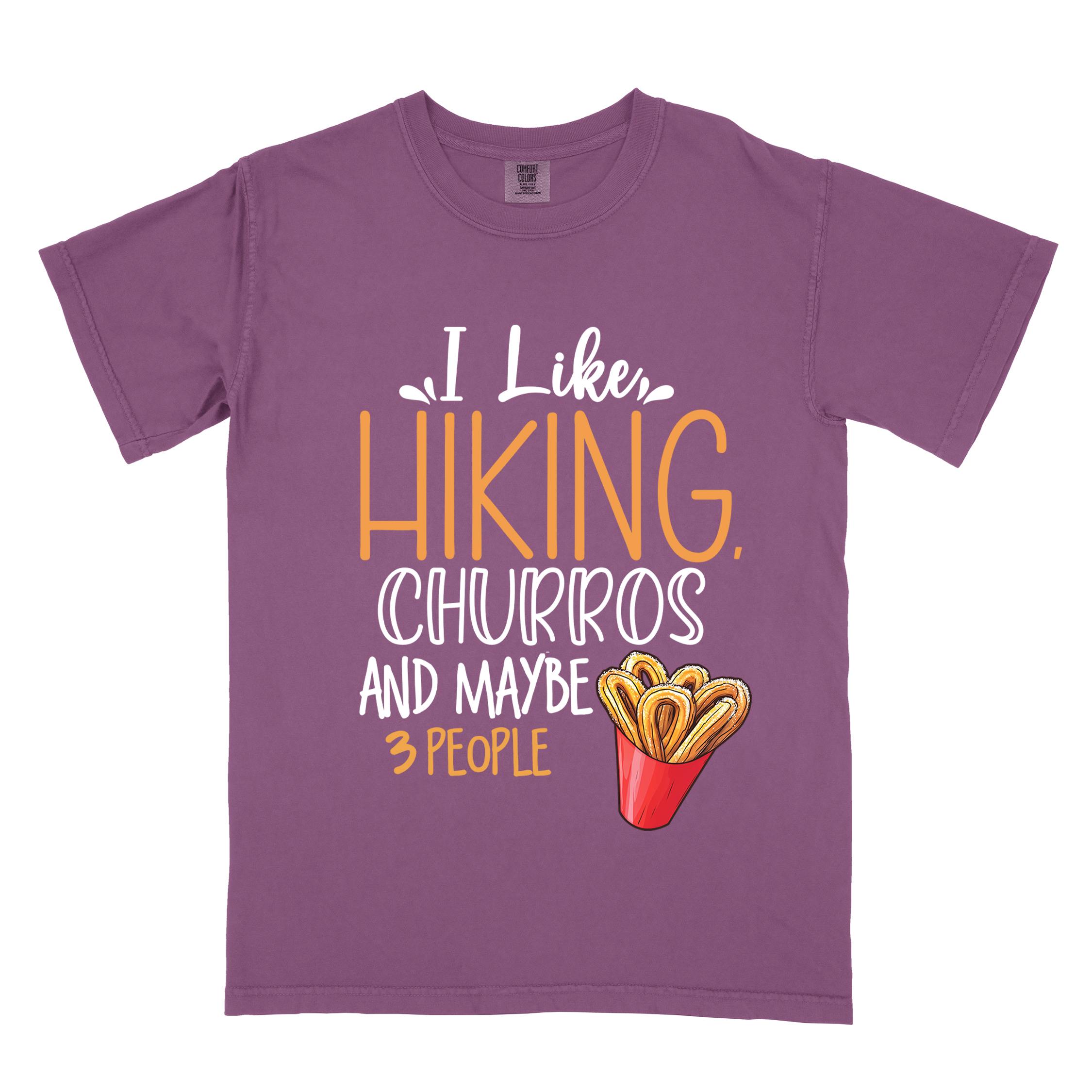 Berry "I like hiking, churros and maybe three people " colored vintage tee with bold typography, mountains, illustrated a serving of Churros, and backpackers with a sweet tooth.