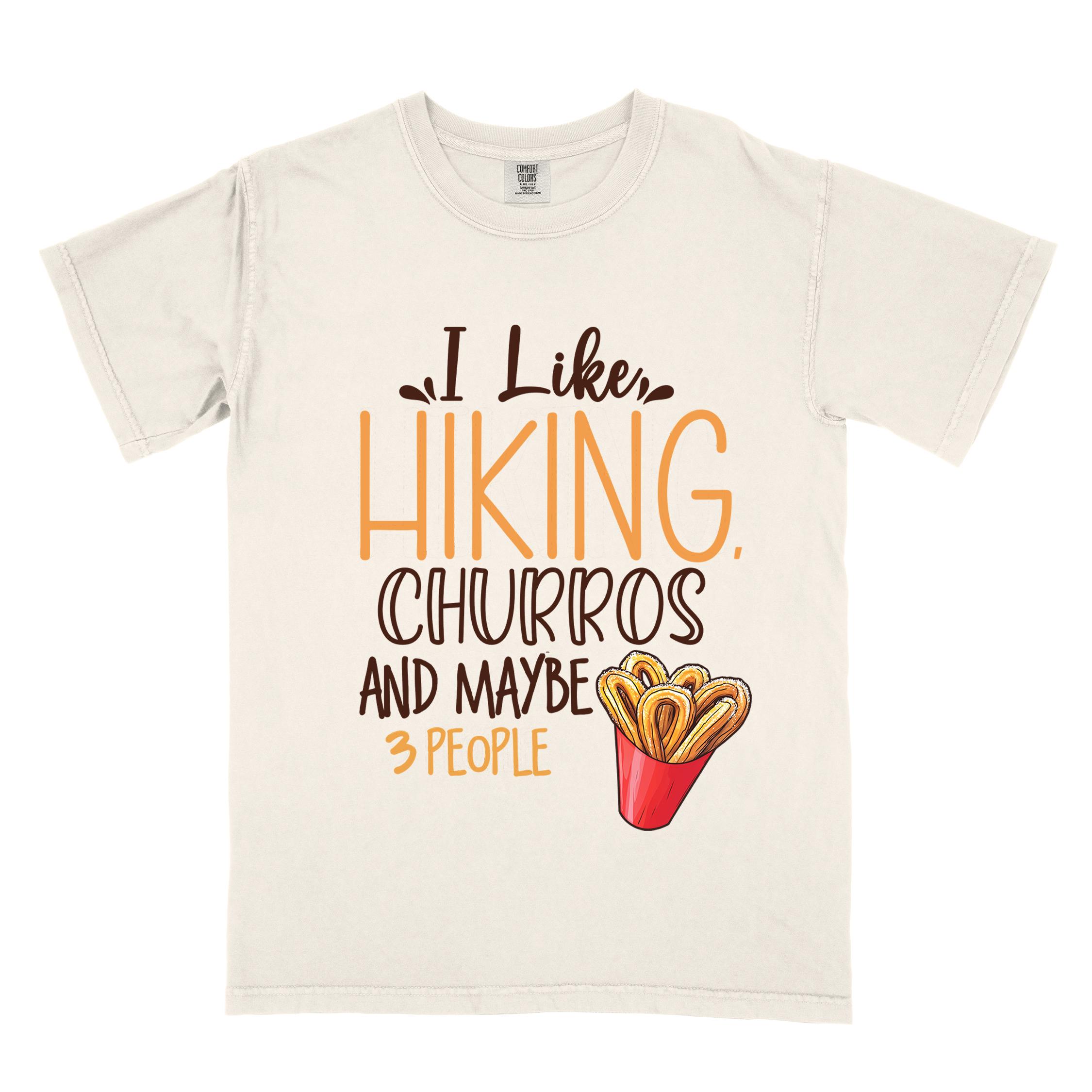 Ivory "I like hiking, churros and maybe three people " colored vintage tee with bold typography, mountains, illustrated a serving of Churros, and backpackers with a sweet tooth.