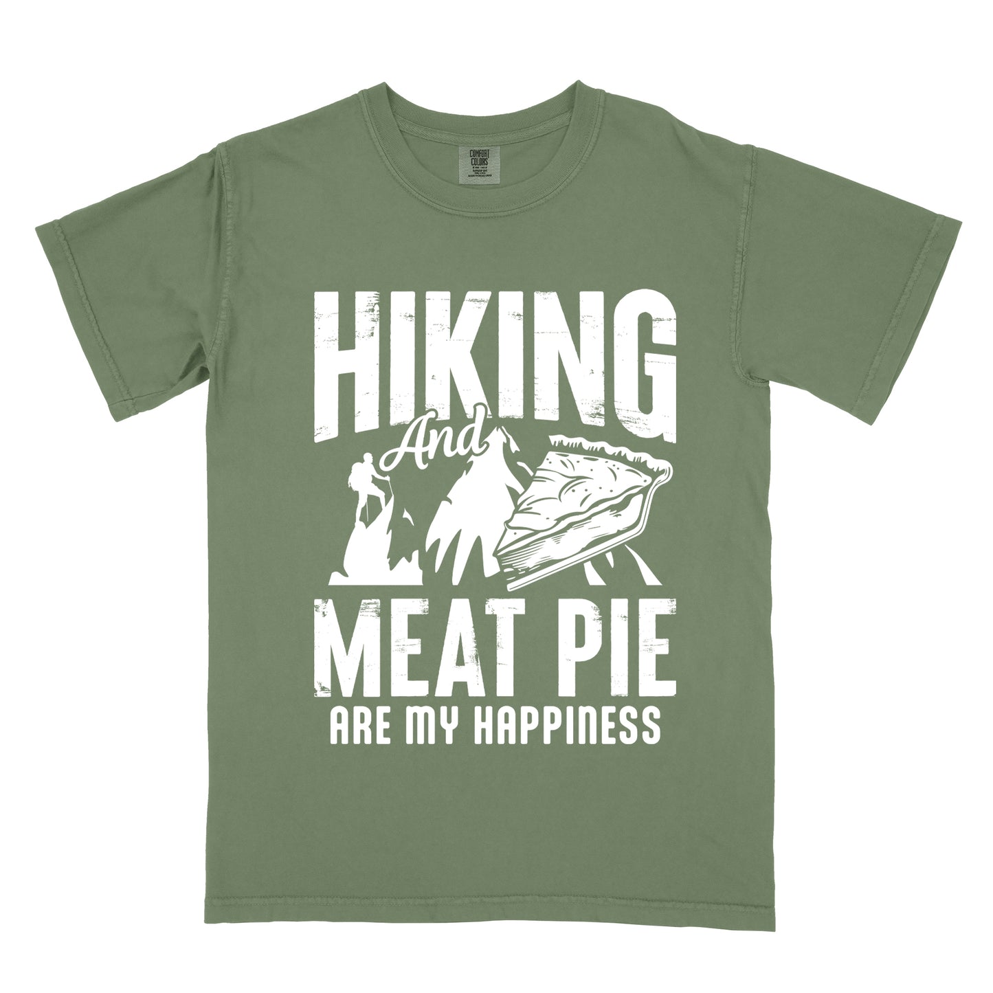 A Moss (Dark Green) t-shirt featuring white distressed text reading "HIKING And MEAT PIE ARE MY HAPPINESS." Between the words "HIKING" and "MEAT PIE" is a graphic showing a mountain silhouette with a tiny hiker climbing it, alongside an illustration of a slice of meat pie. The design uses only white graphics and text on the Moss (Dark Green) shirt background in a rugged, vintage style.