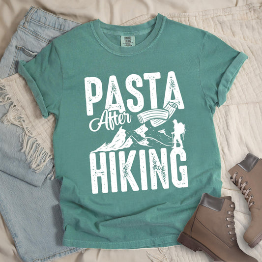 Green shirt with the phrase “Pasta After Hiking.” Includes a hiker silhouette, mountain outline, and pasta noodle illustration.