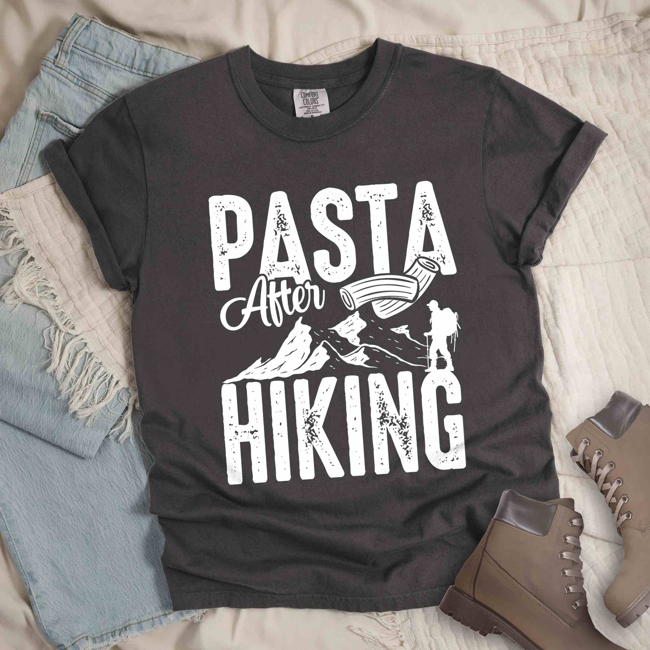 Pepper "Pasta after hiking" colored vintage tee with bold typography, birds, mountains, illustrated pieces of pasta, and backpackers for pasta lovers.