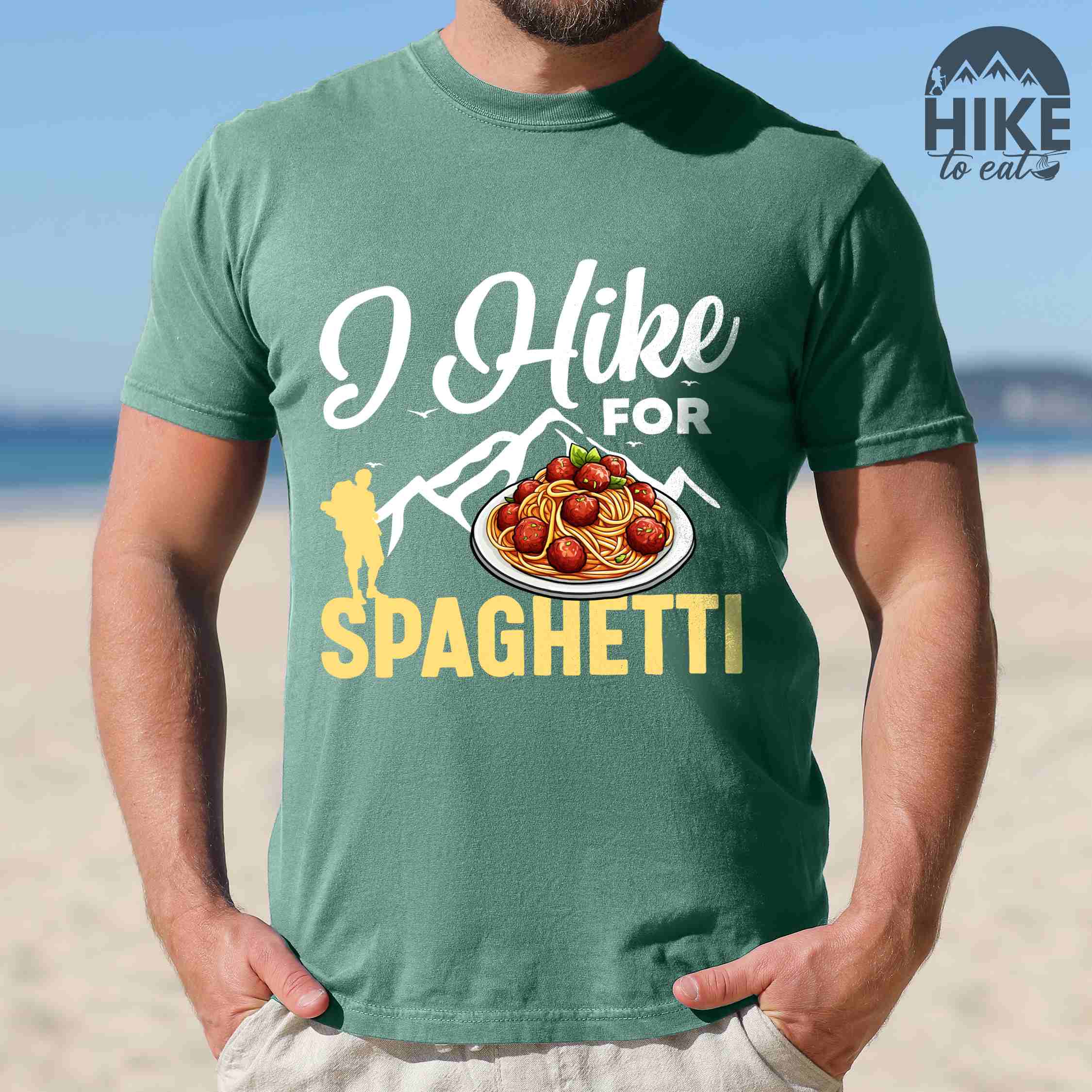 Man wearing light green "I hike for spaghetti" colored vintage tee with bold typography, illustrated plate of spaghetti meatballs, and backpackers for pasta lovers.